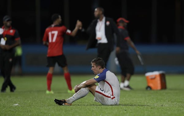 United States' Matt Besler, squats on the pitch after losing 2-1 against Trinidad and Tobago during a 2018 World Cup qualifying soccer match in Couva,
