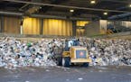 Piles of trash are collected on the tipping floor and loaded onto a conveyor belt for compost bag identification and separation on Nov. 9, 2023, at Ra