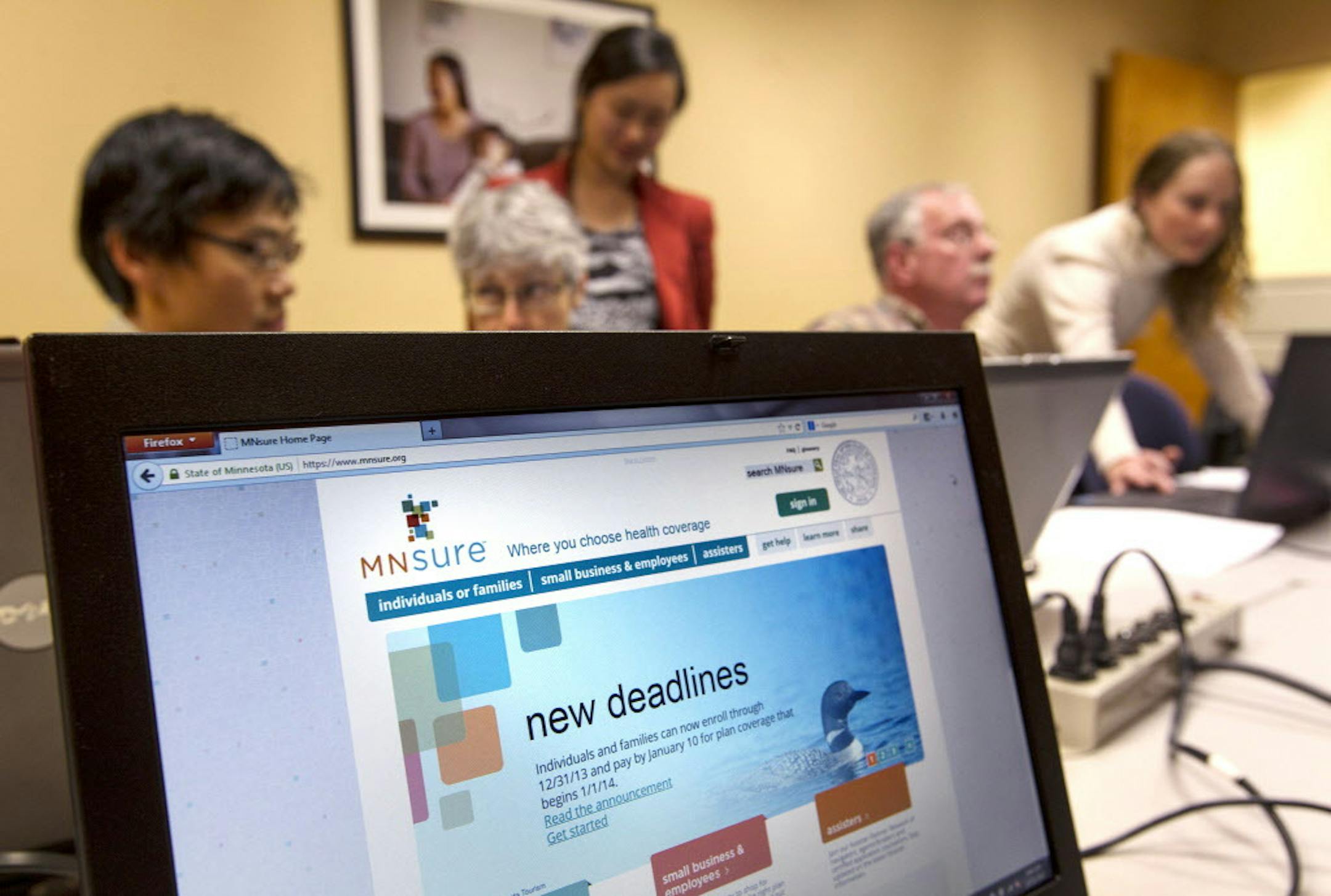In this Dec. 21, 2013 file photo, navigators help Minnesotans sign up for MNsure health benefits before the deadline for coverage during all-day small group sessions at Portico in St. Paul.
