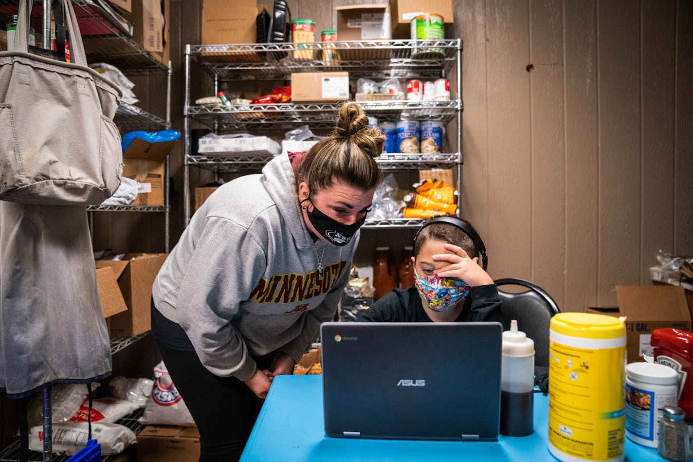 With the help of his mother Amy Jore, who was working a waitressing shift, Henry Jore, 10, watched a video for his fifth-grade class in the storeroom and office of his family's restaurant, Kaddy's Kafe, in La Crescent. La Crescent-Hokah Middle/High School has been closed due to COVID-19 infections and is set to reopen for in-person classes on October 26.