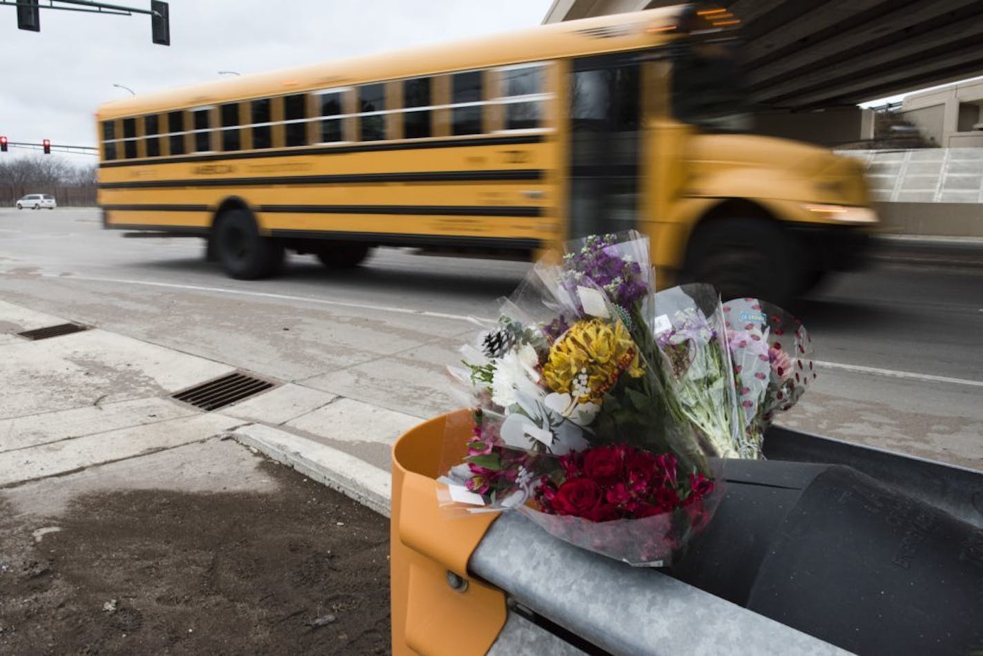 Flowers, tire tracks, and broken glass marked the scene of Thursday's fatal collision.