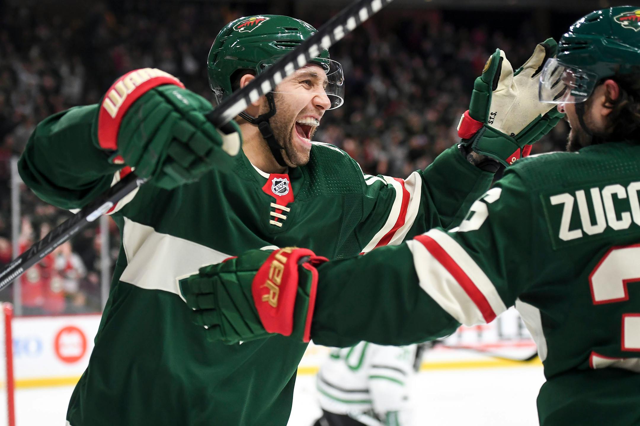 Wild left winger Jason Zucker, left, celebrated with right winger Mats Zuccarello after Zuccarello's second-period goal in a 7-0 rout of the Dallas Stars on Saturday.