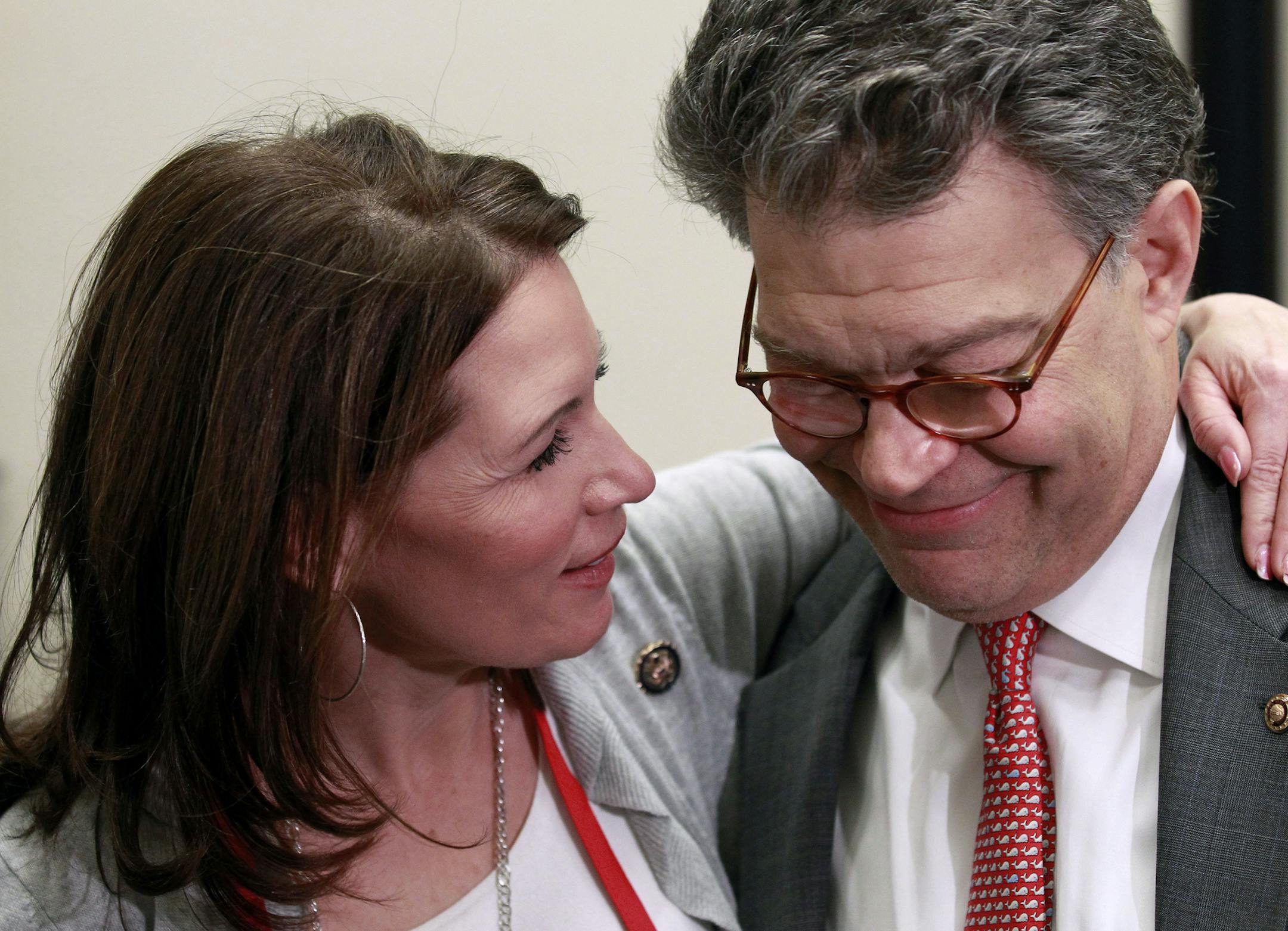 Rep. Michele Bachmann, R-Minn., left, talks with Sen. Al Franken, D-Minn., during the "Hot Dish Off," cooking contest in Franken's office on Capitol Hill in Washington, Wednesday, Jan. 26, 2011. (AP Photo/Alex Brandon) ORG XMIT: MIN2012081720422125