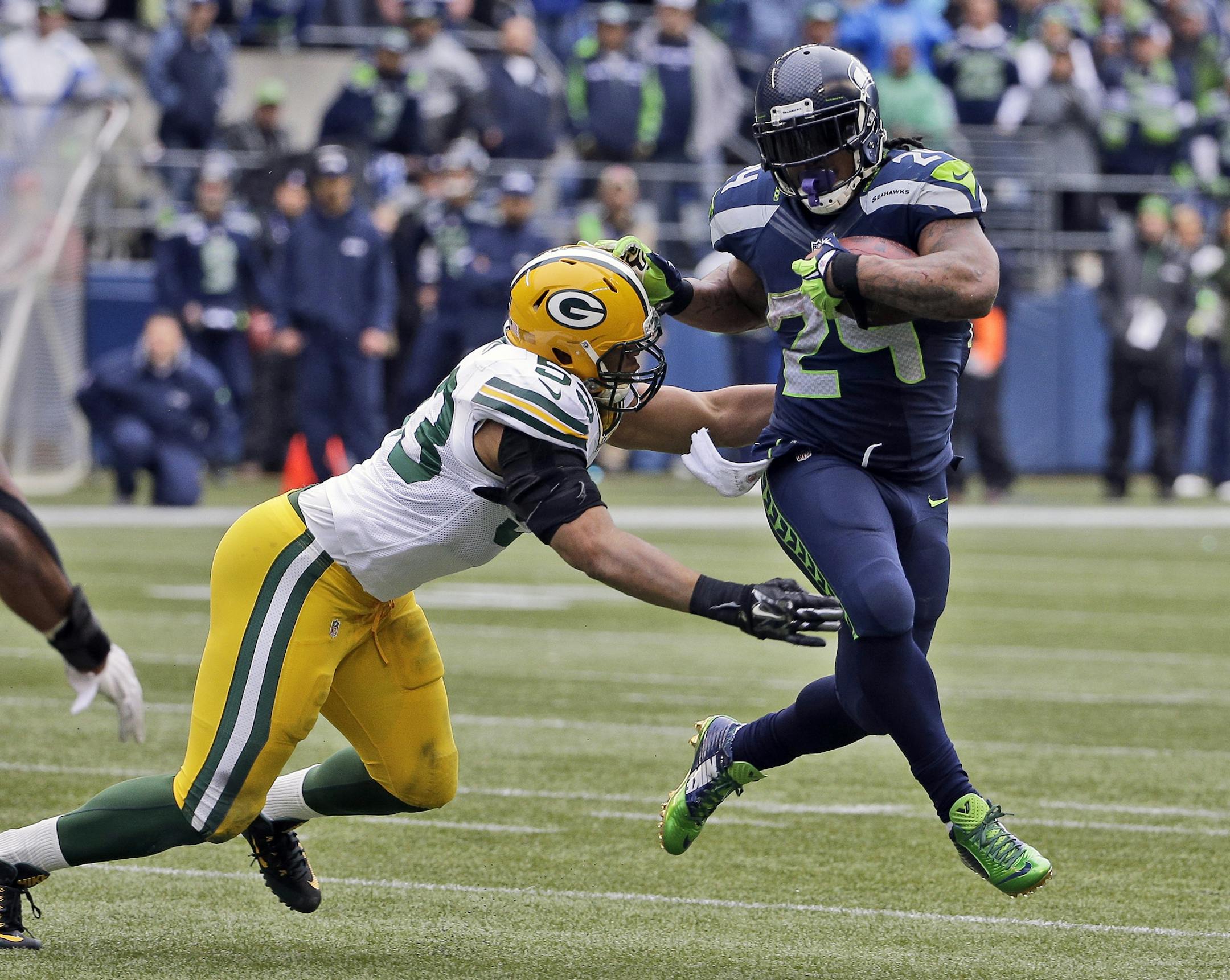 Seattle Seahawks' Marshawn Lynch runs against Green Bay Packers' Nick Perry (53) during the second half of the NFL football NFC Championship game Sunday, Jan. 18, 2015, in Seattle. (AP Photo/David J. Phillip) ORG XMIT: NFC193