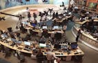 In this Thursday, June 8, 2017 photo, Al-Jazeera staff work at their TV station in Doha, Qatar. The Arab news network Al-Jazeera has been thrust into 