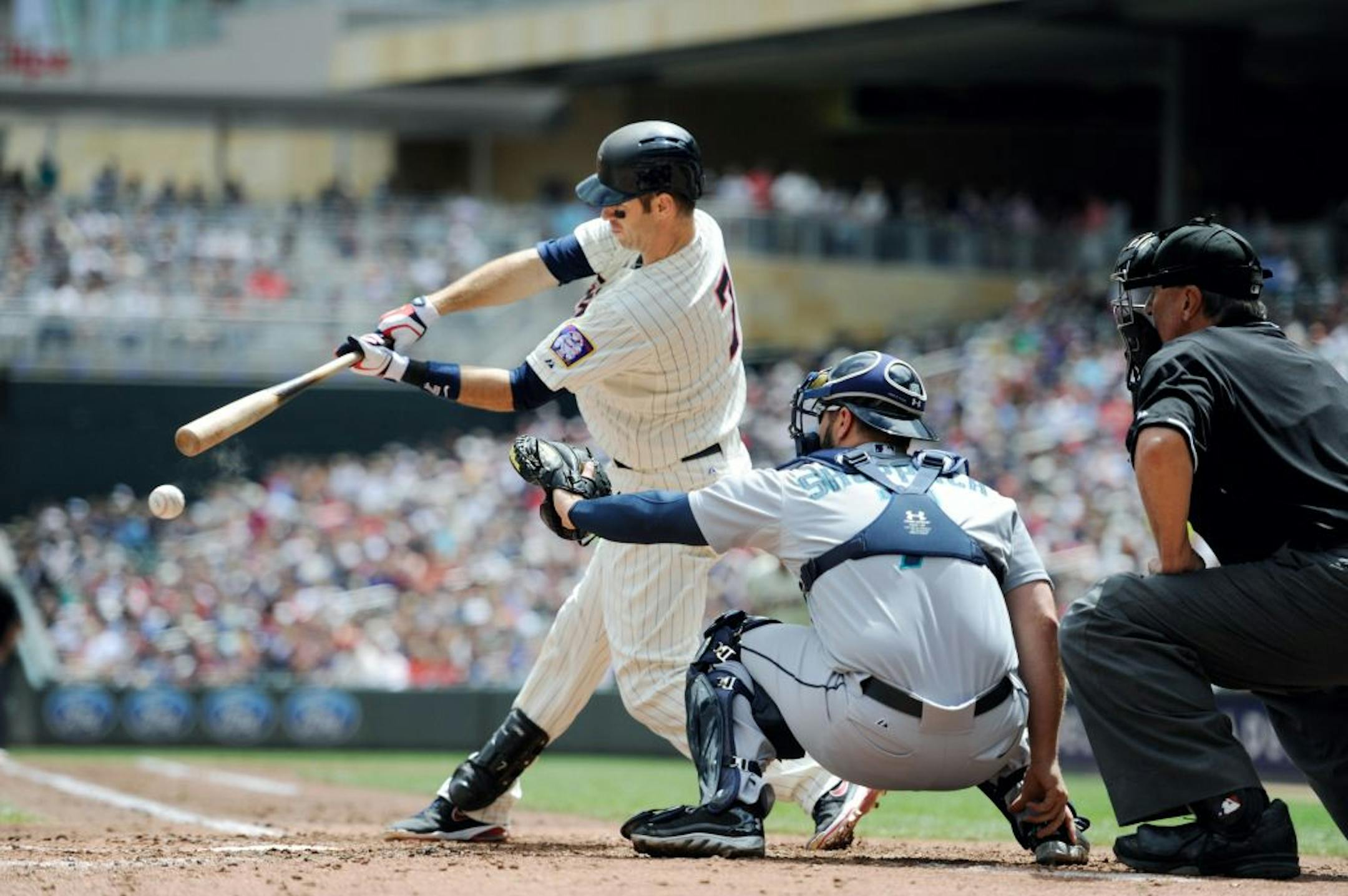 Joe Mauer against Seattle Mariners pitcher Aaron Harang during the third inning of a baseball game, Saturday, June 1, 2013, in Minneapolis.
