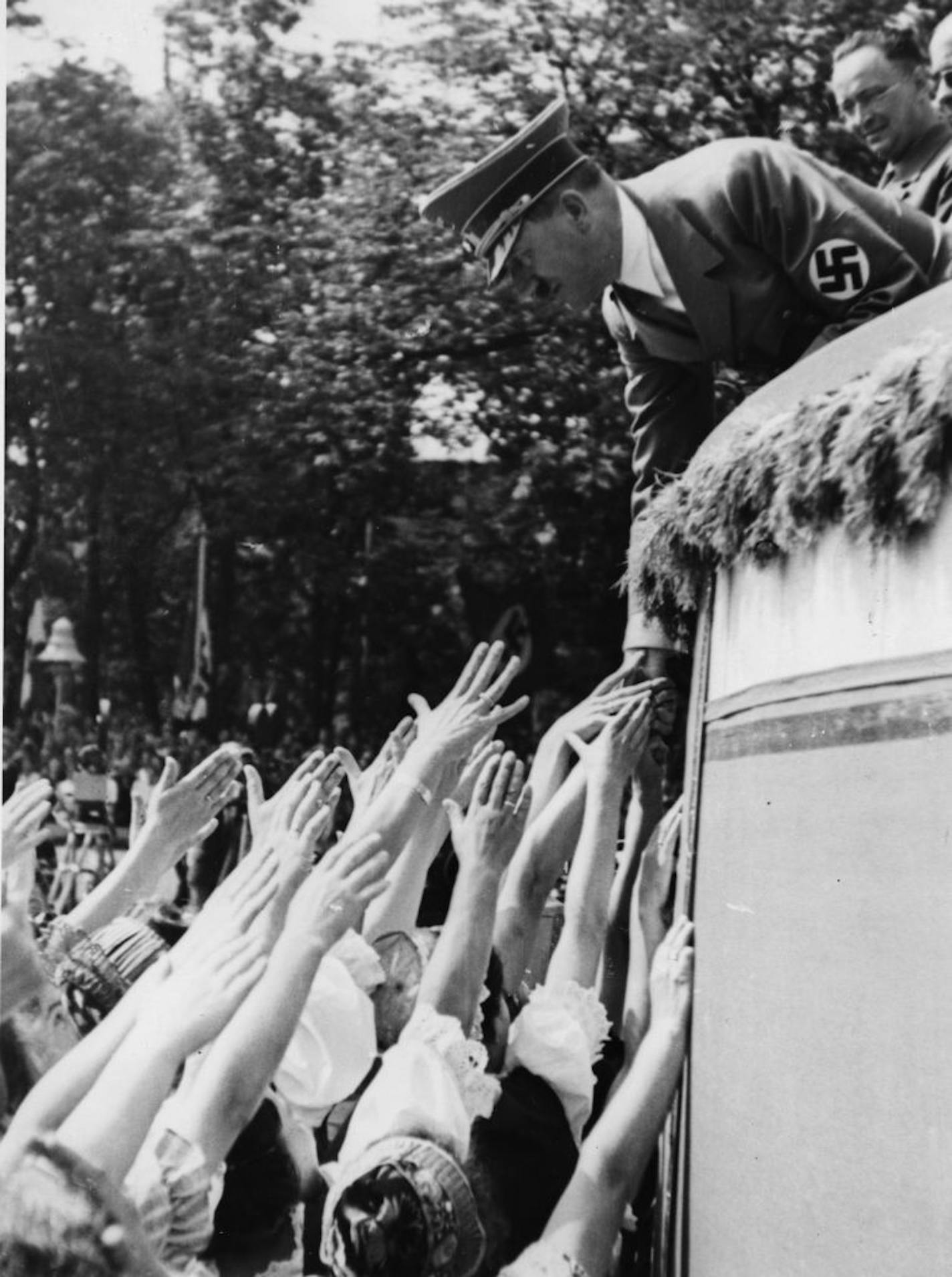 Sudetengerman girls greet Adolf Hitler and shake hands with him on the last day of the big German sports festival in Breslau, Silesia, on July 31, 1938.