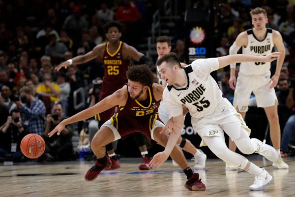 Gophers guard Gabe Kalscheur went for a loose ball with Purdue's Sasha Stefanovic on Friday, when Kalscheur shut down Boilermakers star Carsen Edwards