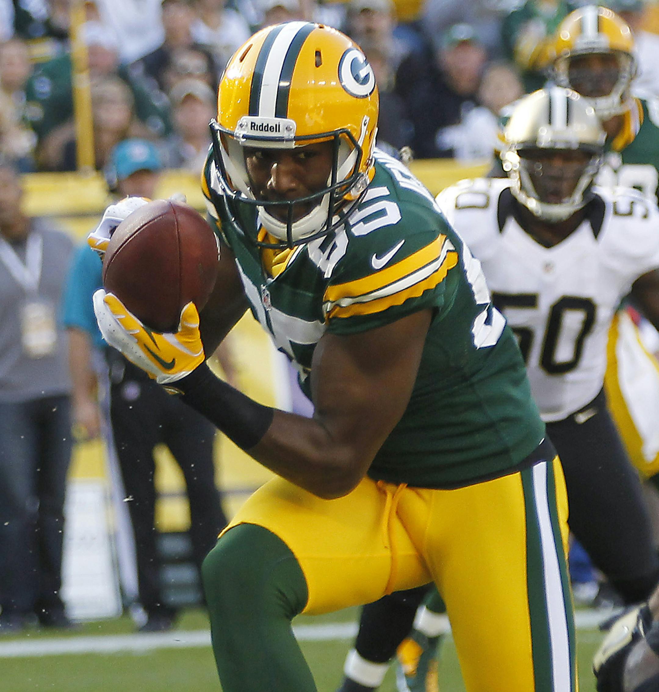 FILE - In this Sept. 30, 2012 file photo, Green Bay Packers wide receiver Greg Jennings catches a touchdown pass in front of New Orleans Saints free safety Isa Abdul-Quddus, right, during the first half of an NFL football game in Green Bay, Wis. The Packers declined to use their franchise tag on Jennings, meaning the star wide receiver will become an unrestricted free agent next week. (AP Photo/Mike Roemer, File)