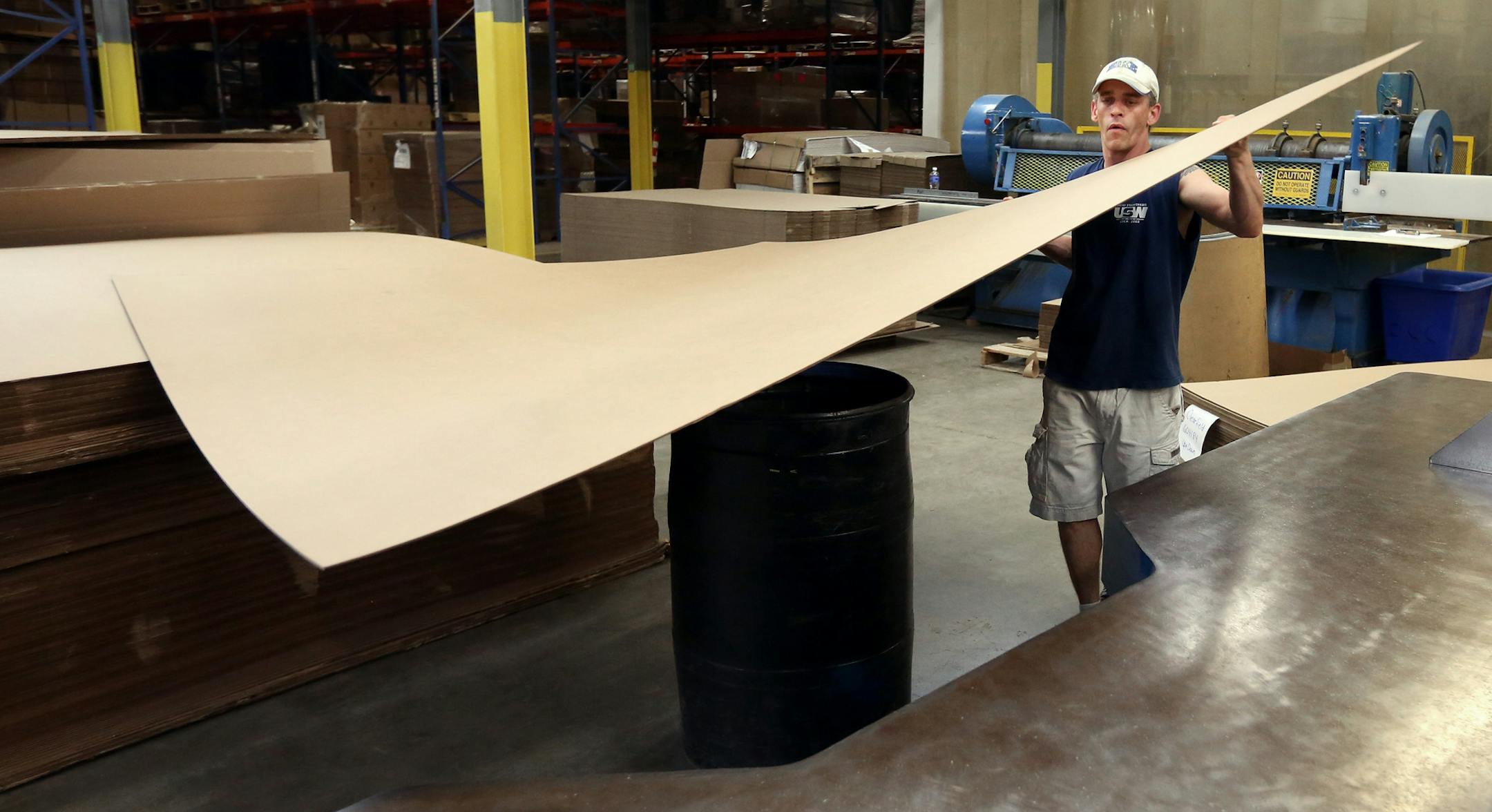 Chad Ross an employee at Central Package for two years loaded corrugated product on too a machine which shaped to it to make boxes Wednesday May 13, 2015 in Brooklyn Park, MN. ] Jerry Holt/ Jerry.Holt@Startribune.com
