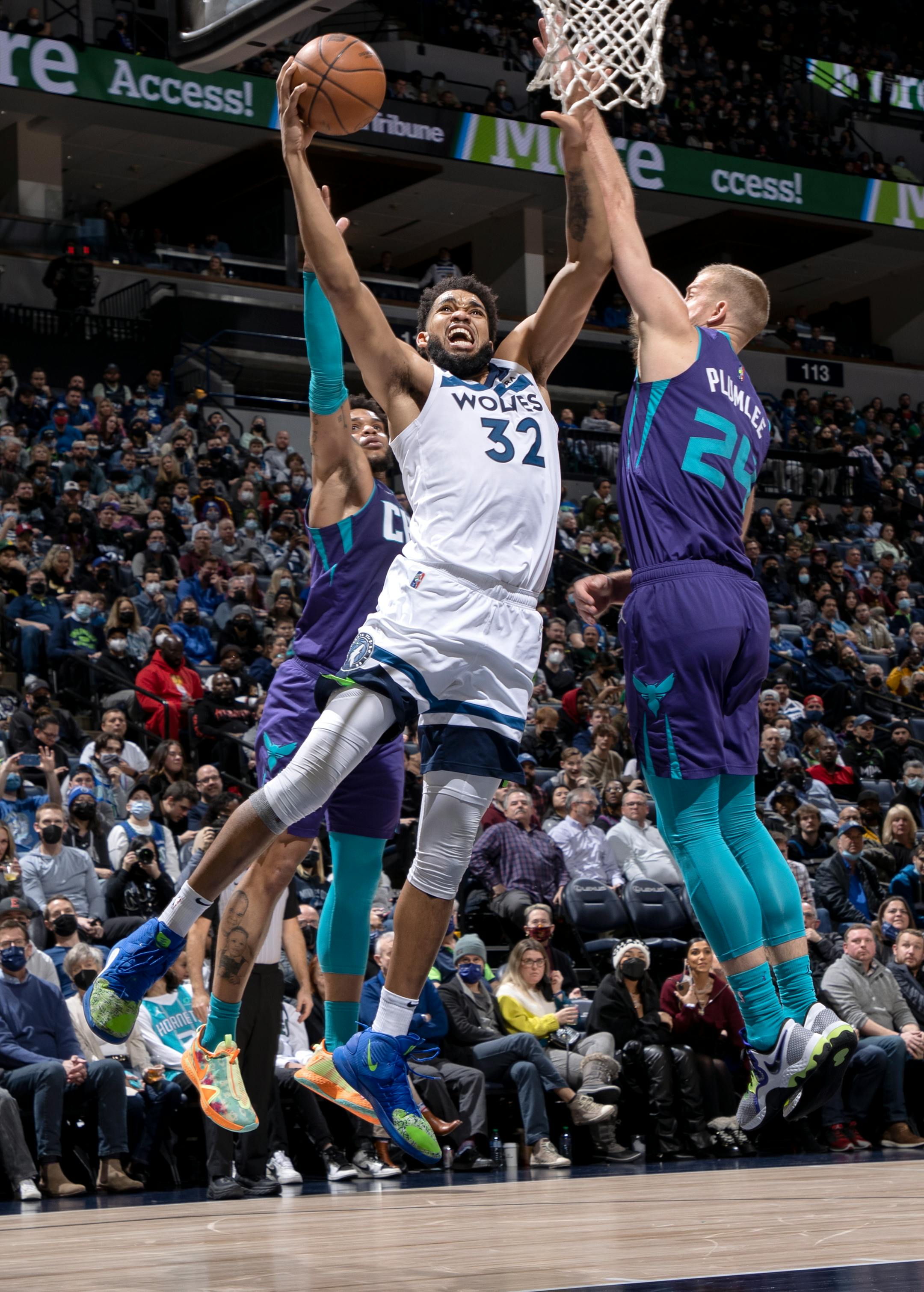 Karl Anthony-Towns (32) of the Minnesota Timberwolves is defended by Mason Plumlee (24) of the Charlotte Hornets in the second quarter.