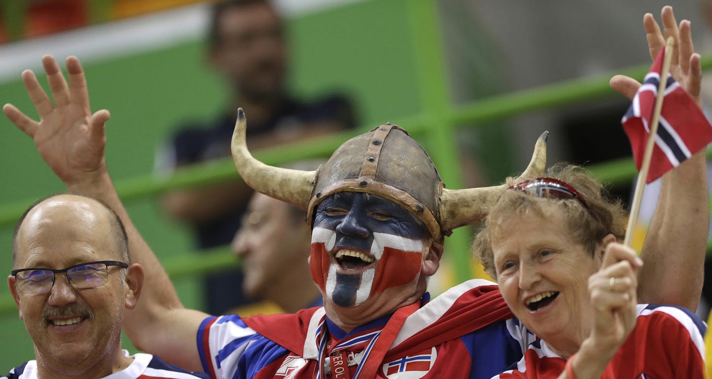 FILE - In this Thursday, Aug. 18, 2016 file photo Norwegian fans wait for the beginning of the women's semifinal handball match between Norway and Russia at the 2016 Summer Olympics in Rio de Janeiro, Brazil. A global happiness report has made the Norwegian foreign minister, well, happy. Reacting to the news Monday that Norway tops the world happiness rankings, edging out Denmark which was No.1 in the previous report. (AP Photo/Matthias Schrader) ORG XMIT: MIN2017032312050339