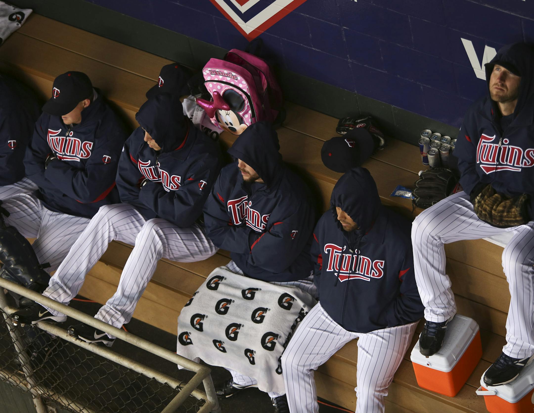 Twins players try to keep warm.