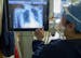 Arlene Ramirez, an MRI technologist, reviews a chest X-ray from a COVID-19 patient in the ICU on May 11, 2020, at St. Anthony Hospital in Chicago. (Br