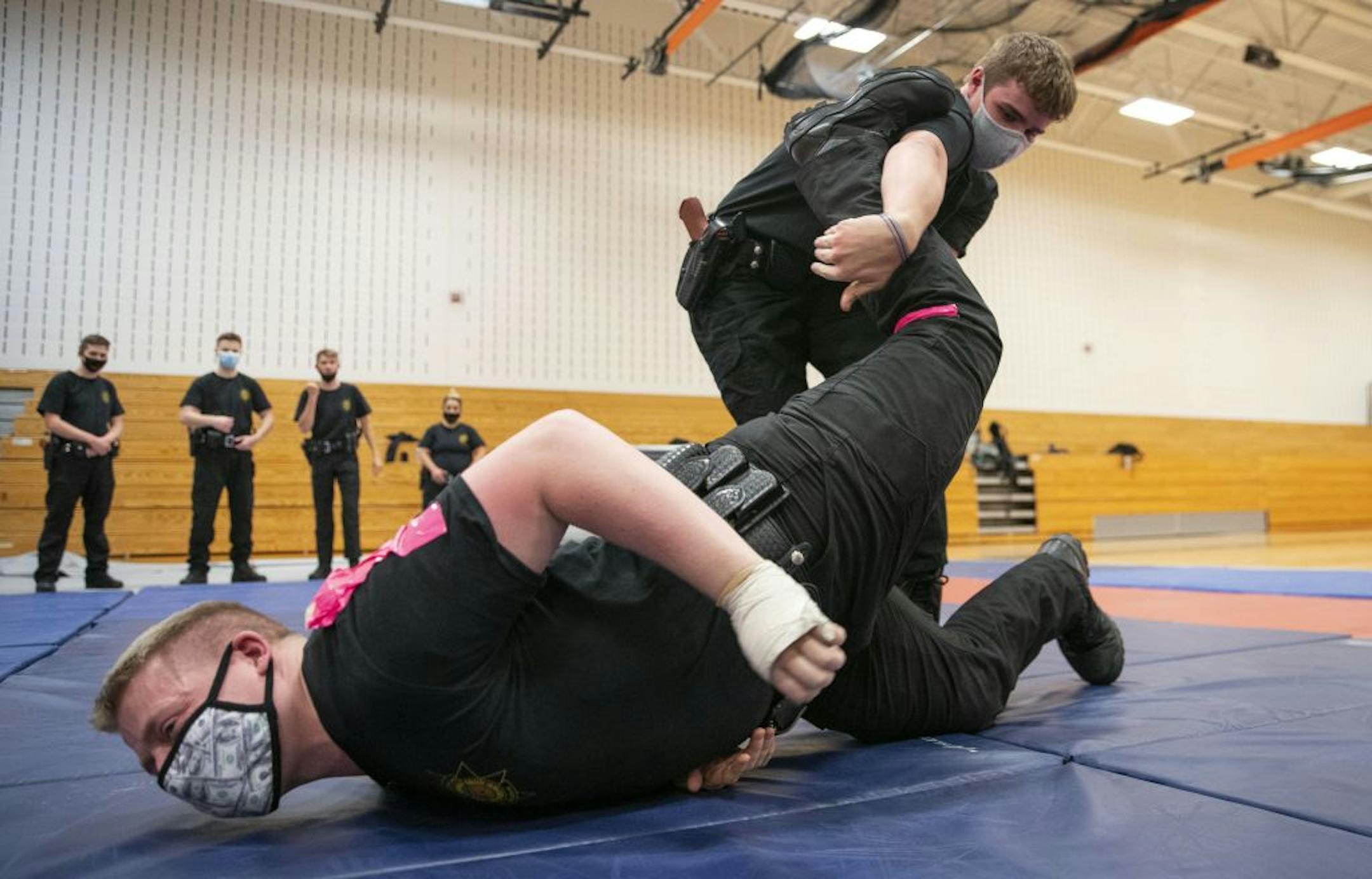 (Top) Lucas Pyrlik practiced proper ground fighting technique with Joshua Radosevich during defensive tactics class at Fond Du Lac Tribal and Community College in Cloquet, Minn. on Tuesday November 17, 2020.