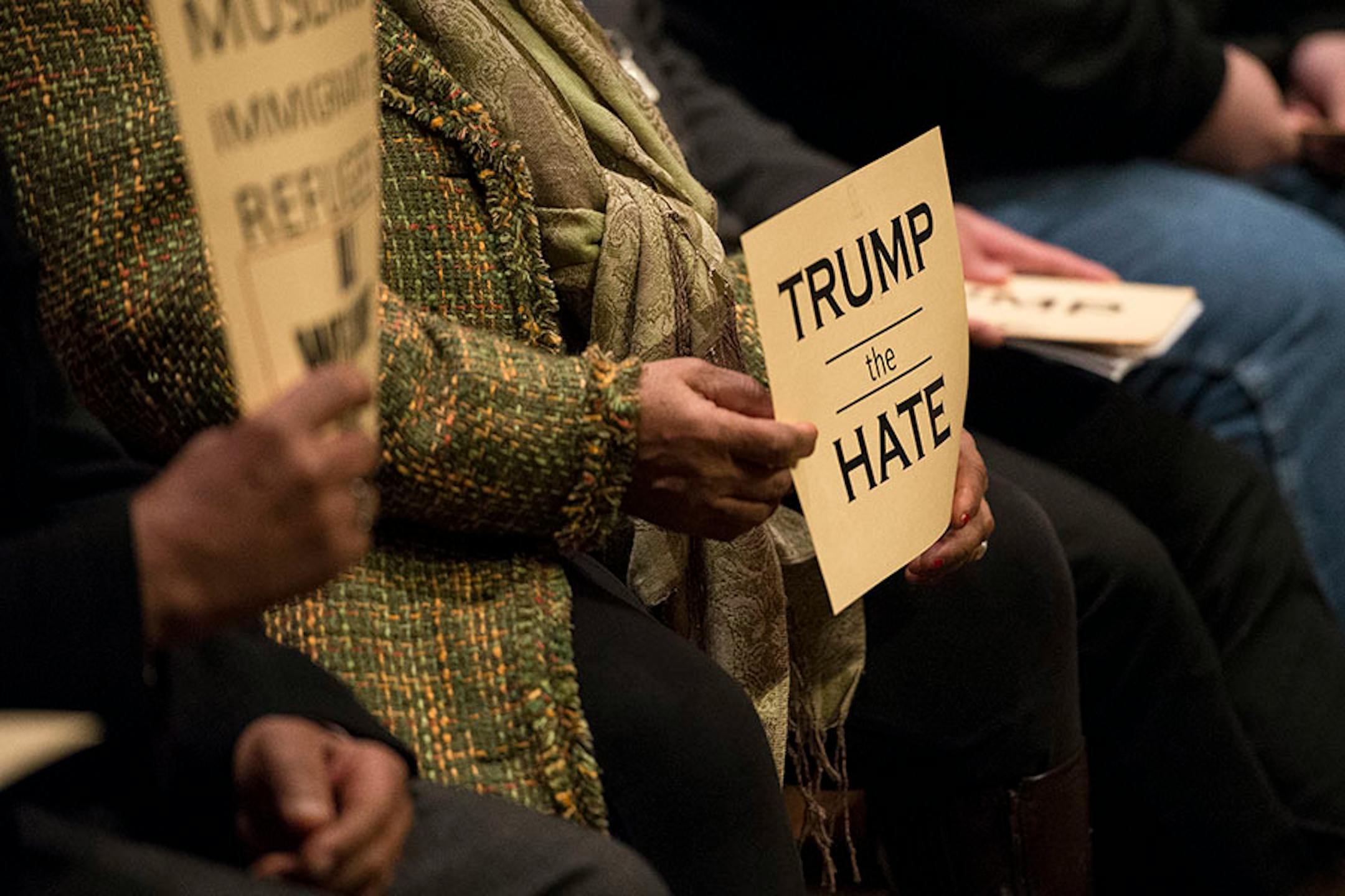 Demonstrators held anti-Trump signs at Wednesday's St. Paul City Council meeting.
