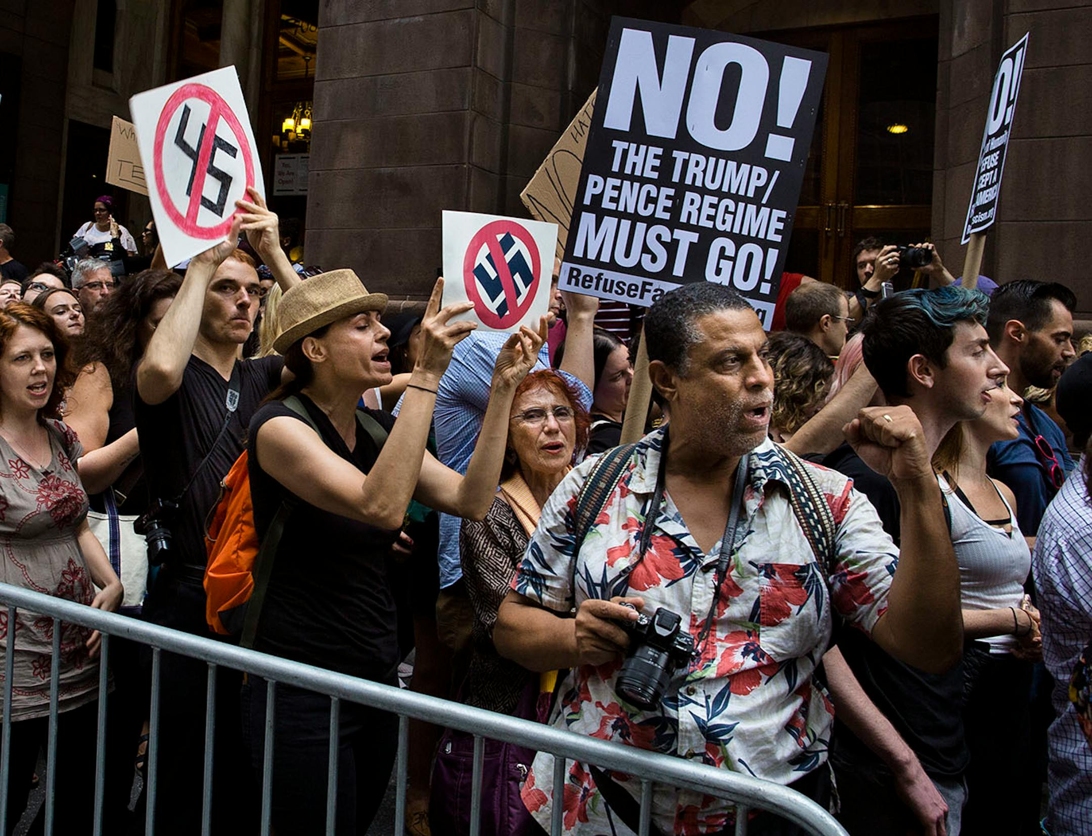 Protestors shout slogans in front of Trump Tower ahead President Donald Trump's visit to the building New York, Monday, Aug. 14, 2017.