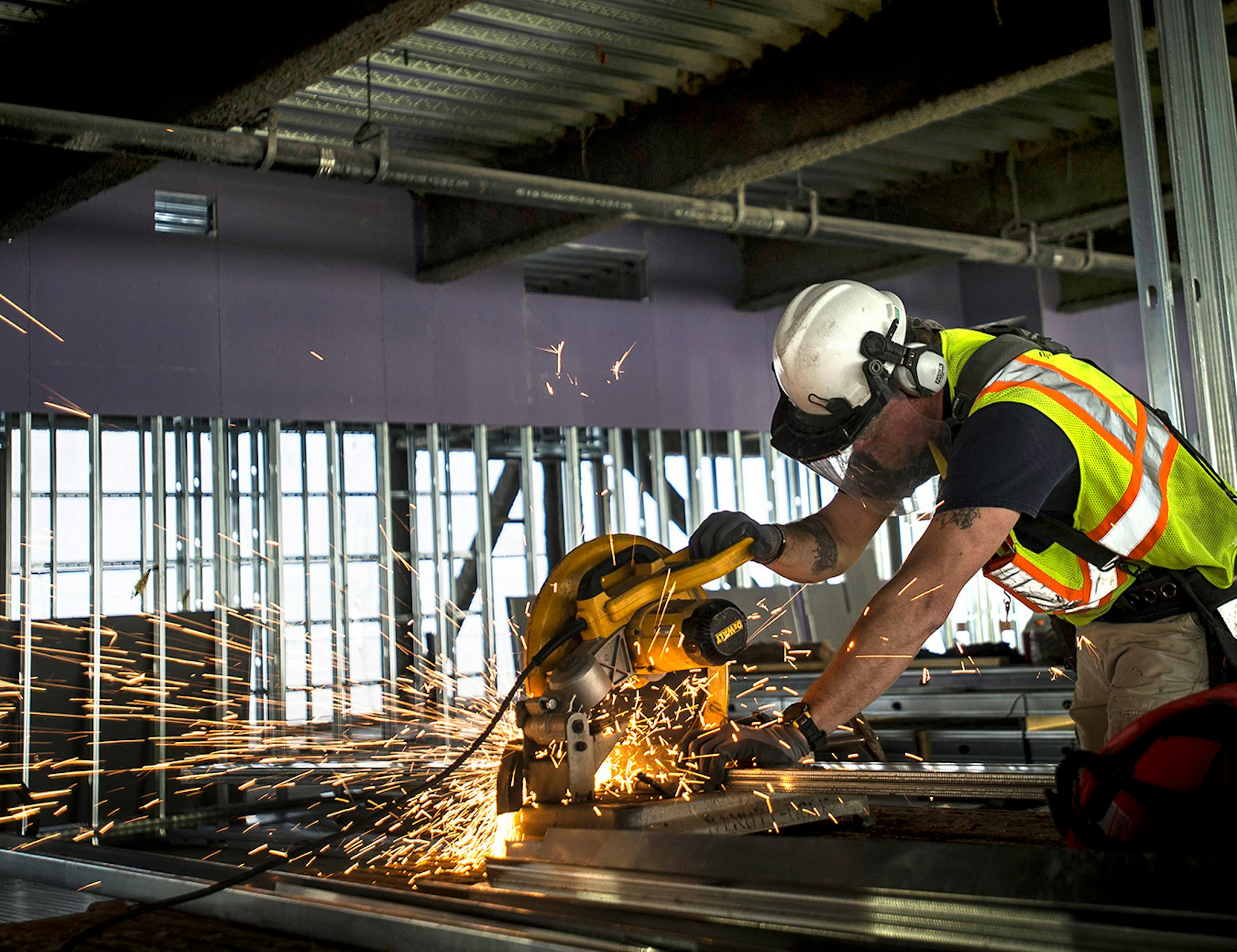 Carpenter Rusty Baier cuts a metal stud at the construction site of the new Senate Office Building on Tuesday afternoon.