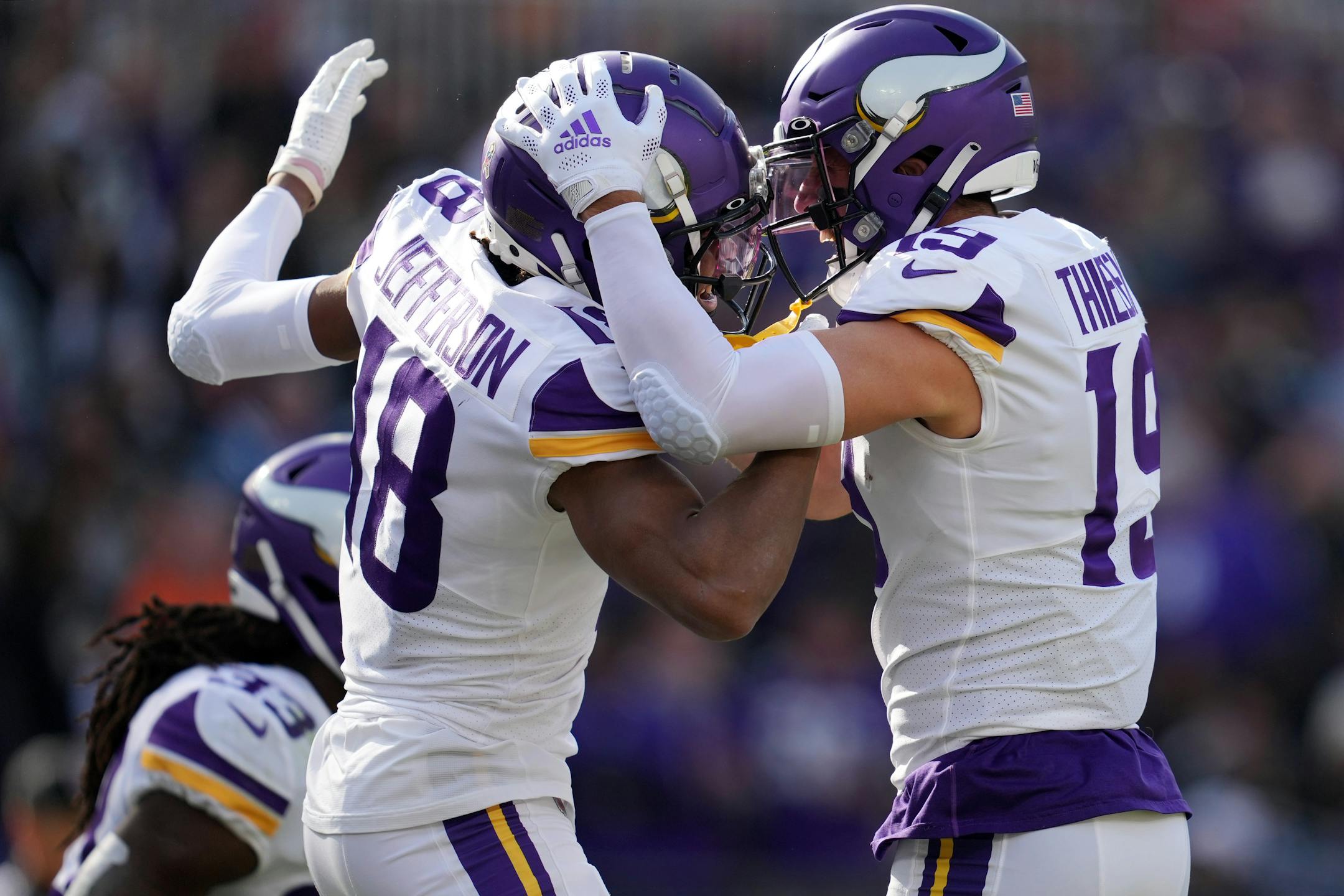 Vikings wide receiver Justin Jefferson (18) celebrates with fellow wide receiver Adam Thielen (19) after running in a 50-yard touchdown pass from quarterback Kirk Cousins (8) in the first quarter.