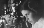 Carrie Fisher as Princess Leia with C3PO in the 1977 release of &#x201c;Star Wars.&#x201d;