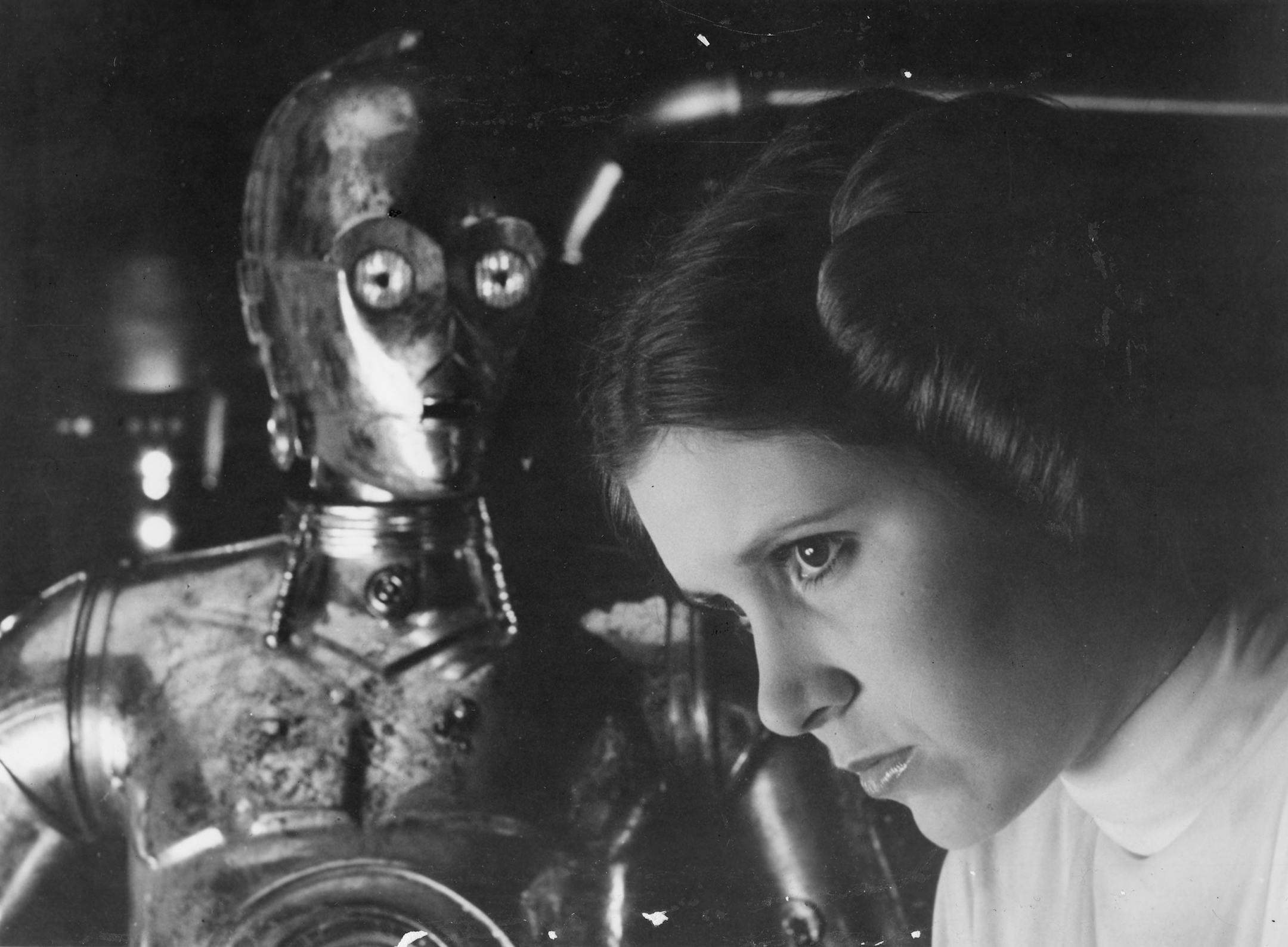 Carrie Fisher as Princess Leia with C3PO in the 1977 release of “Star Wars.”