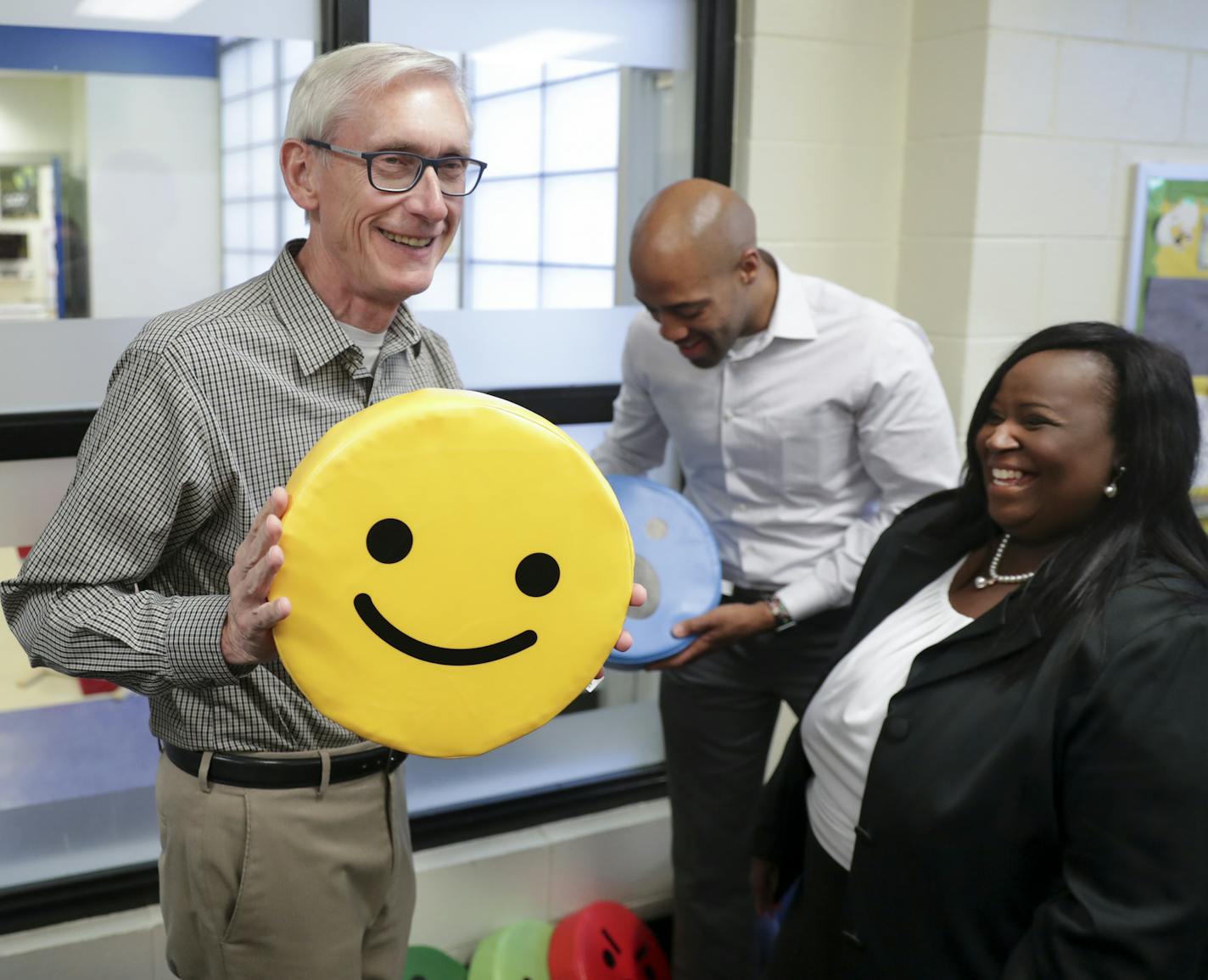 Governor-elect Tony Evers, left, and Lt. Governor-elect Mandela Barnes, right, with pillows found on the tour of the Boys & Girls Club of Dane County. State Rep-elect Shelia Stubbs (D-Madison) is right. On Wednesday Nov. 7, 2018 Governor-elect Tony Evers, and Lt. Governor elect Mandela Barnes took a tour of the Boys & Girls Club of Dane County in Madison, Wis. (Steve Apps/Wisconsin State Journal via AP)