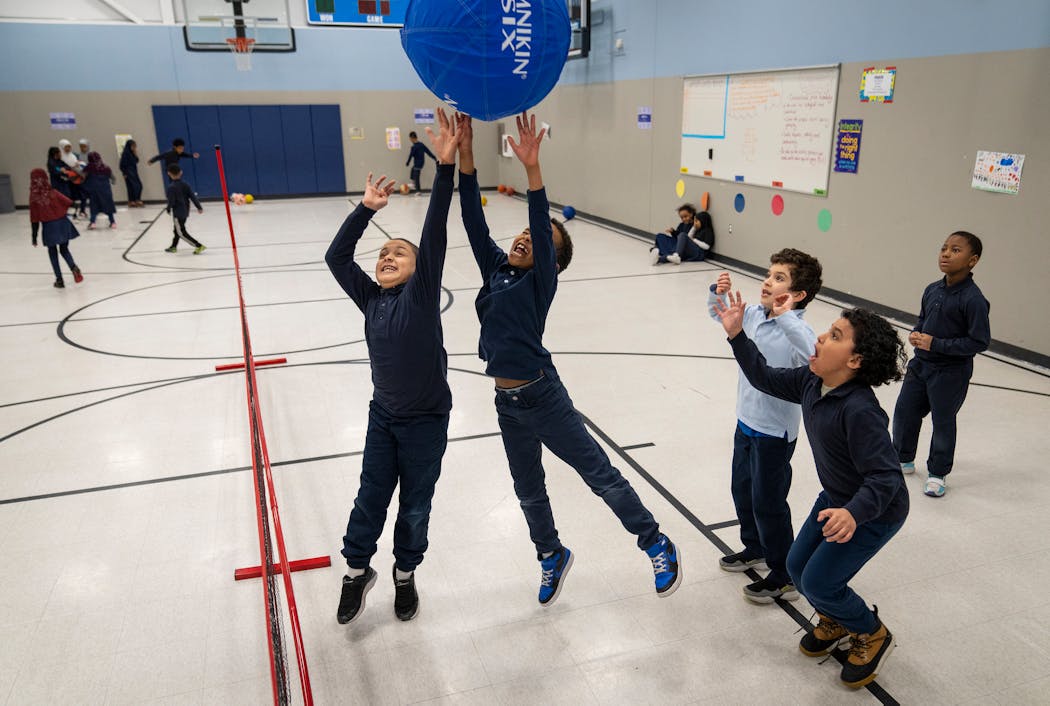 Second-graders play a rousing game of beach volleyball during gym class at Global Academy in New Brighton on Tuesday. From left is Mohamed Gomma, Osman Gass, Abdurrahman Al-Warraky, Yassin Elmetwalli and Idris Selby.