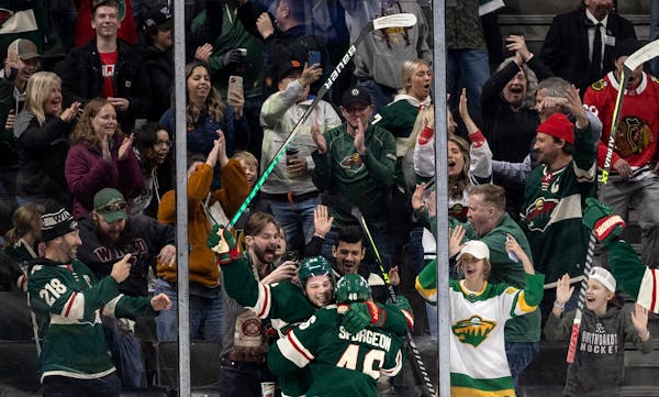 Kevin Fiala (22) and Jared Spurgeon (46) of the Minnesota Wild celebrates a game winning overtime goal by Spurgeon.