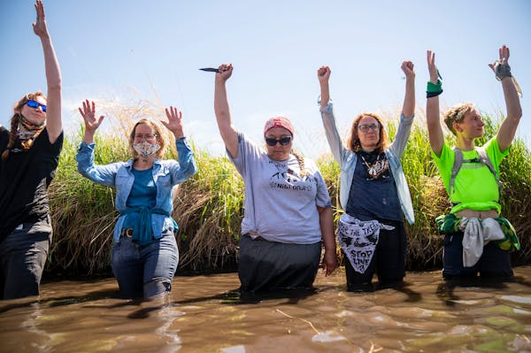 Everlasting Wind aka Dawn Goodwin joined others by raising her fist in the Mississippi River near an Enbridge pipeline construction site on Monday. Sh