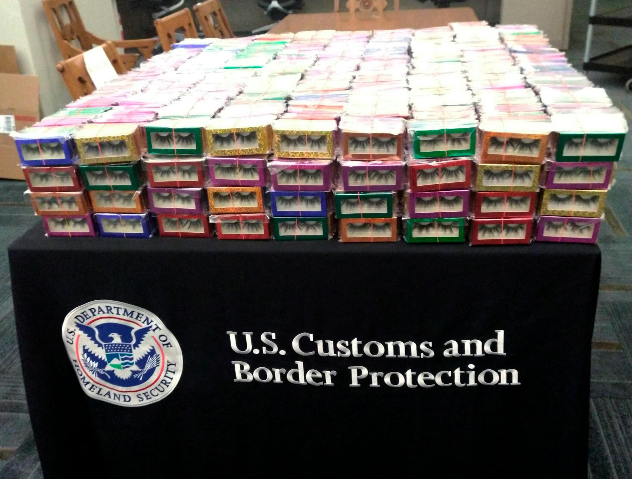 This photo provided by U.S. Customs and Border Protection shows boxes of long lashes seized Tuesday, July 6, 2021 at Louis Armstrong New Orleans International Airport. Three thousand pairs of false eyelashes have been seized by U.S. Customs and Border Protection agents after officials determined they were illegally imported from China to New Orleans. Agency spokesperson Matthew Dyman tells WVUE-TV that the four boxes of long lashes seized Tuesday were destined for a local beauty supply store.(U.S. Customs and Border Protection via AP)