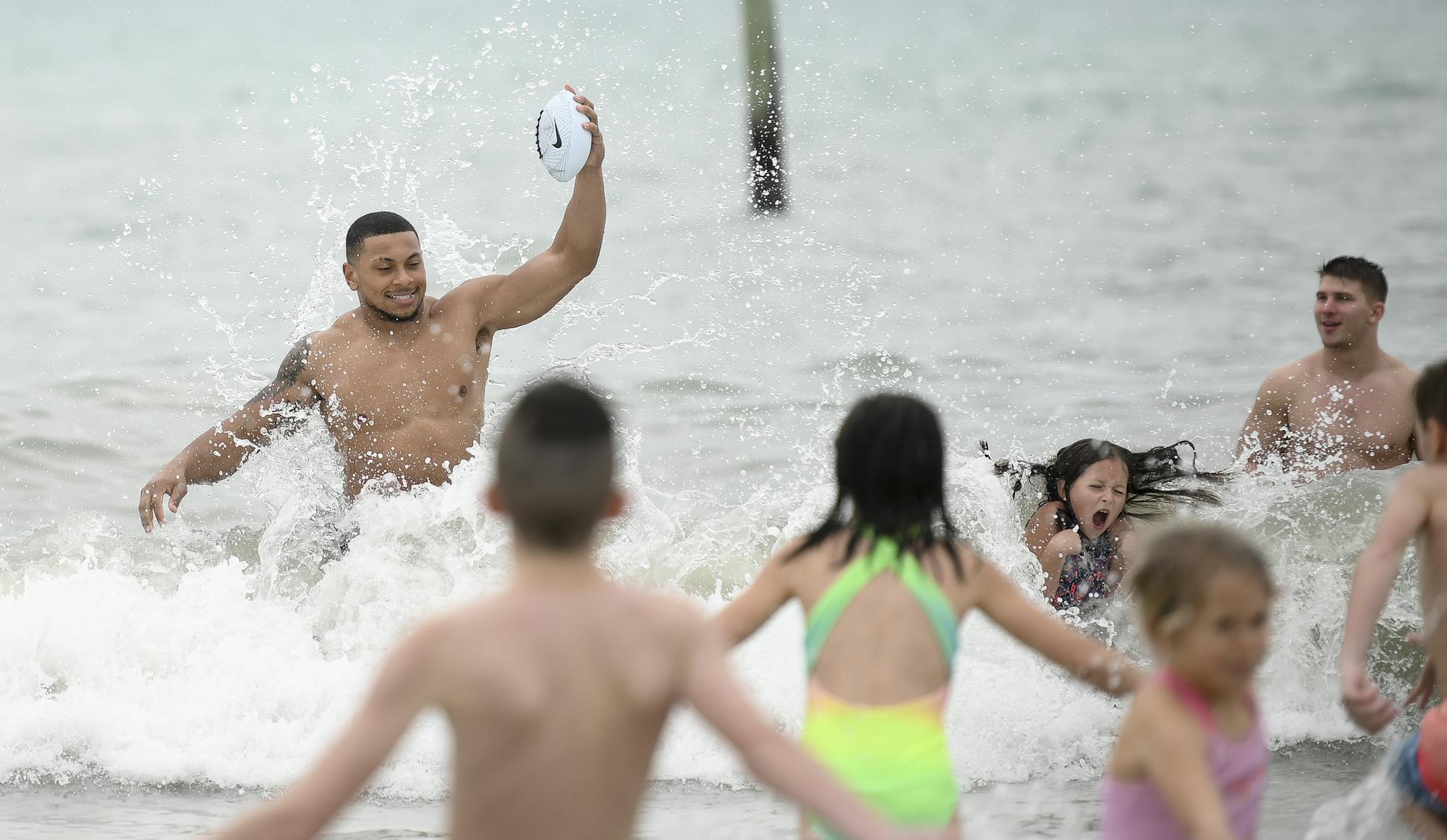 Minnesota Gophers defensive back Antoine Winfield Jr. (11) played in the surf with teammates and a group of kids during the Outback Bowl's Beach Day Monday. ] Aaron Lavinsky • aaron.lavinsky@startribune.com The Outback Bowl's Beach Day was held Monday, Dec. 30, 2019 at Clearwater Beach, Fla. The event featured exhibitions from the University of Minnesota and Auburn's marching bands, a tug-of-war competition between cheer squads and gave fans the opportunity to interact with student athlet