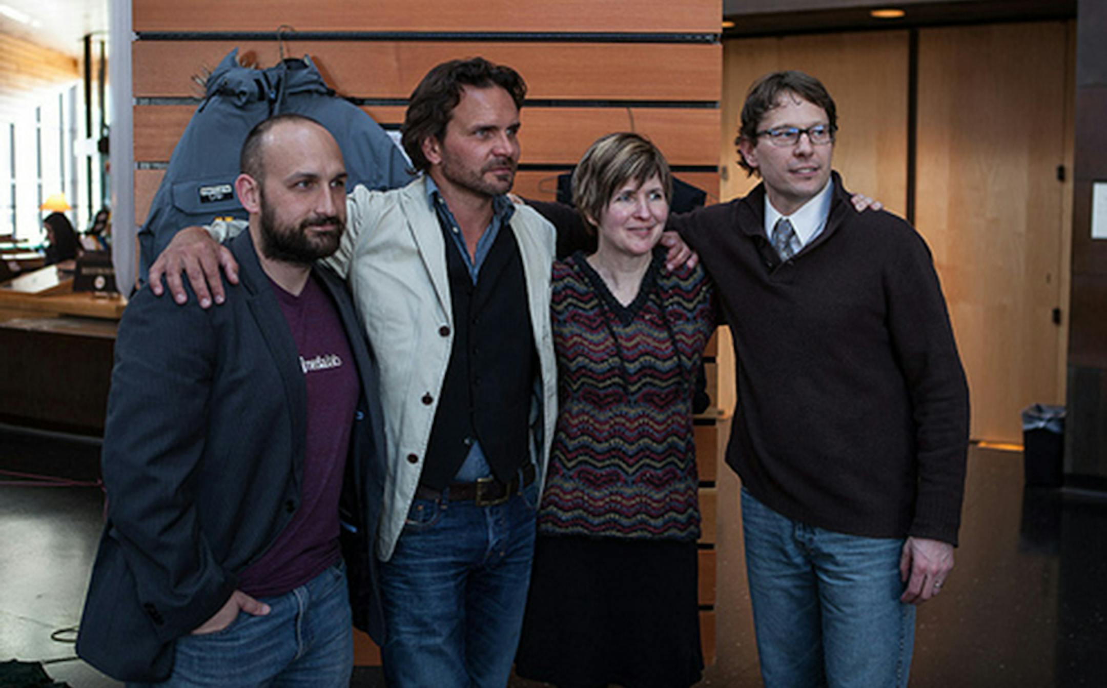 Four members of the North of Sixty team celebrate their upcoming expedition at a University of Minnesota sendoff event. They are (left tor right) University of Minnesota PhD student and new media developer Brad Hosack, University of Minnesota Associate Professor Aaron Doering, graduate research assistant and PhD candidate Jeni Henrickson and Centennial High School geography teacher Chris Ripken.