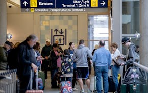 Travelers navigate the Uber/Lyft rideshare area in Terminal 1 at Minneapolis-St. Paul International Airport on March 22, 2024.