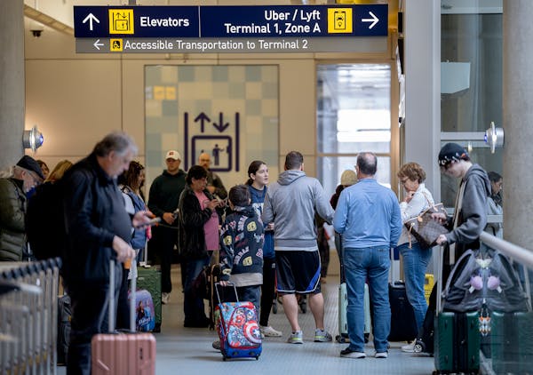 Travelers navigate the Uber/Lyft rideshare area in Terminal 1 at Minneapolis-St. Paul International Airport on March 22, 2024.