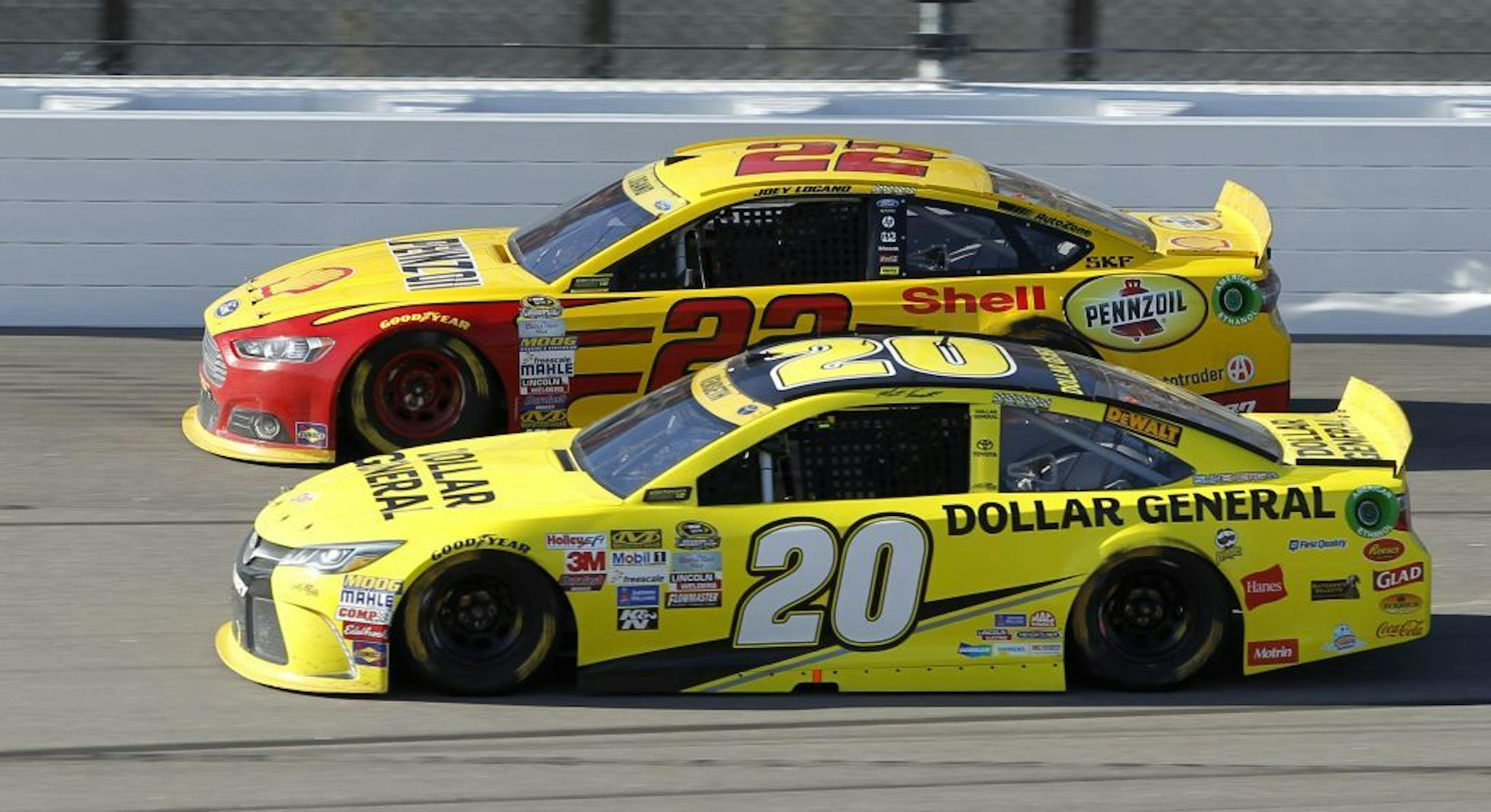 Sprint Cup Series driver Joey Logano (22) and Matt Kenseth (20) run side-by-side during a NASCAR auto race at Kansas Speedway in Kansas City, Kan., Sunday, Oct. 18, 2015.