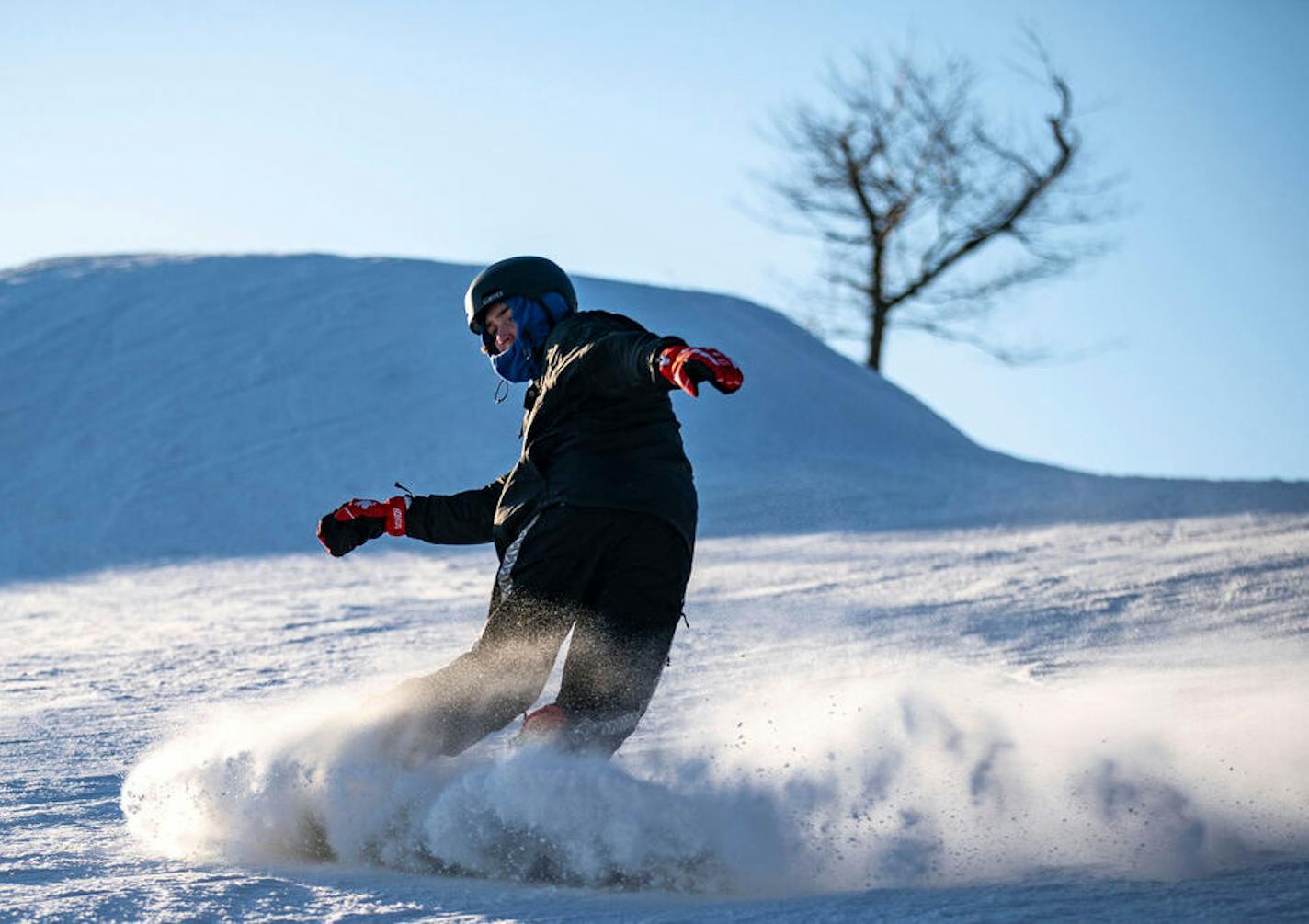 Clockwise from top: The sun rose over Spirit Mountain in Duluth, casting light on Lake Superior and the St. Louis River. Snowboarders practiced their skills at the ski area's terrain park last year.