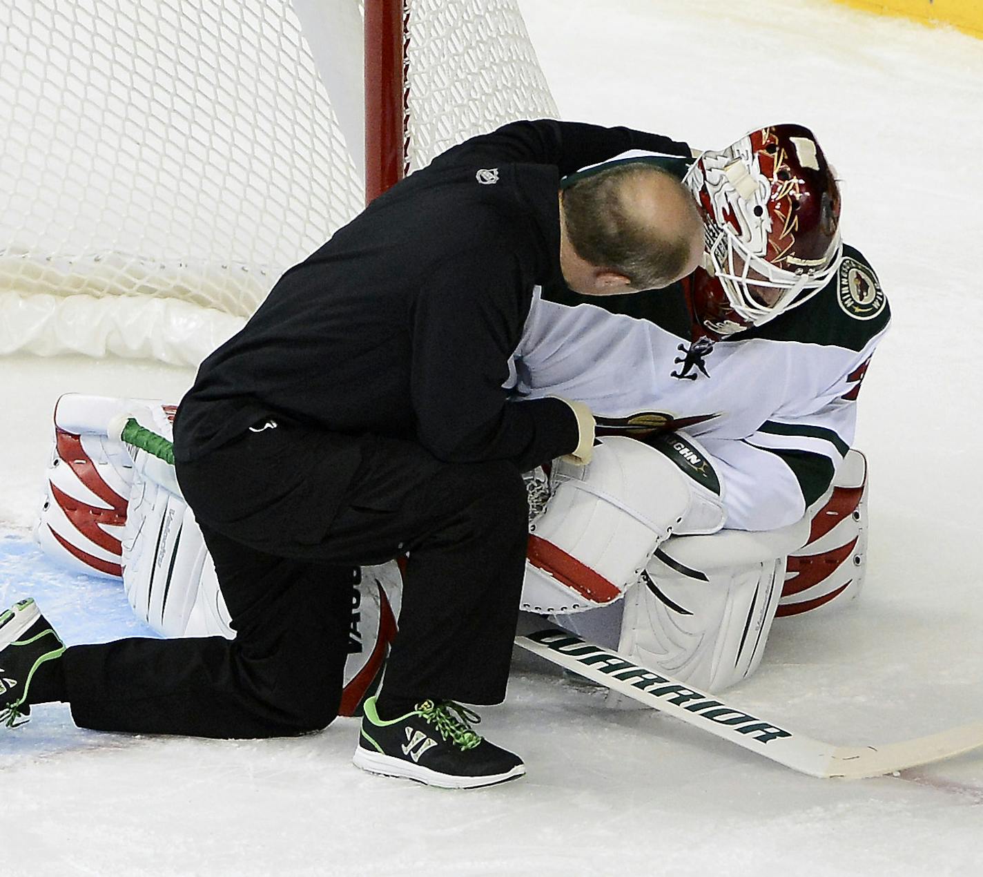 Minnesota Wild goalie Niklas Backstrom, right, of Finland, is attended to after colliding with Nashville Predators forward Eric Nystrom and was taken out of the game in the first period of an NHL hockey game on Tuesday, Oct. 8, 2013, in Nashville, Tenn. (AP Photo/Mark Zaleski)