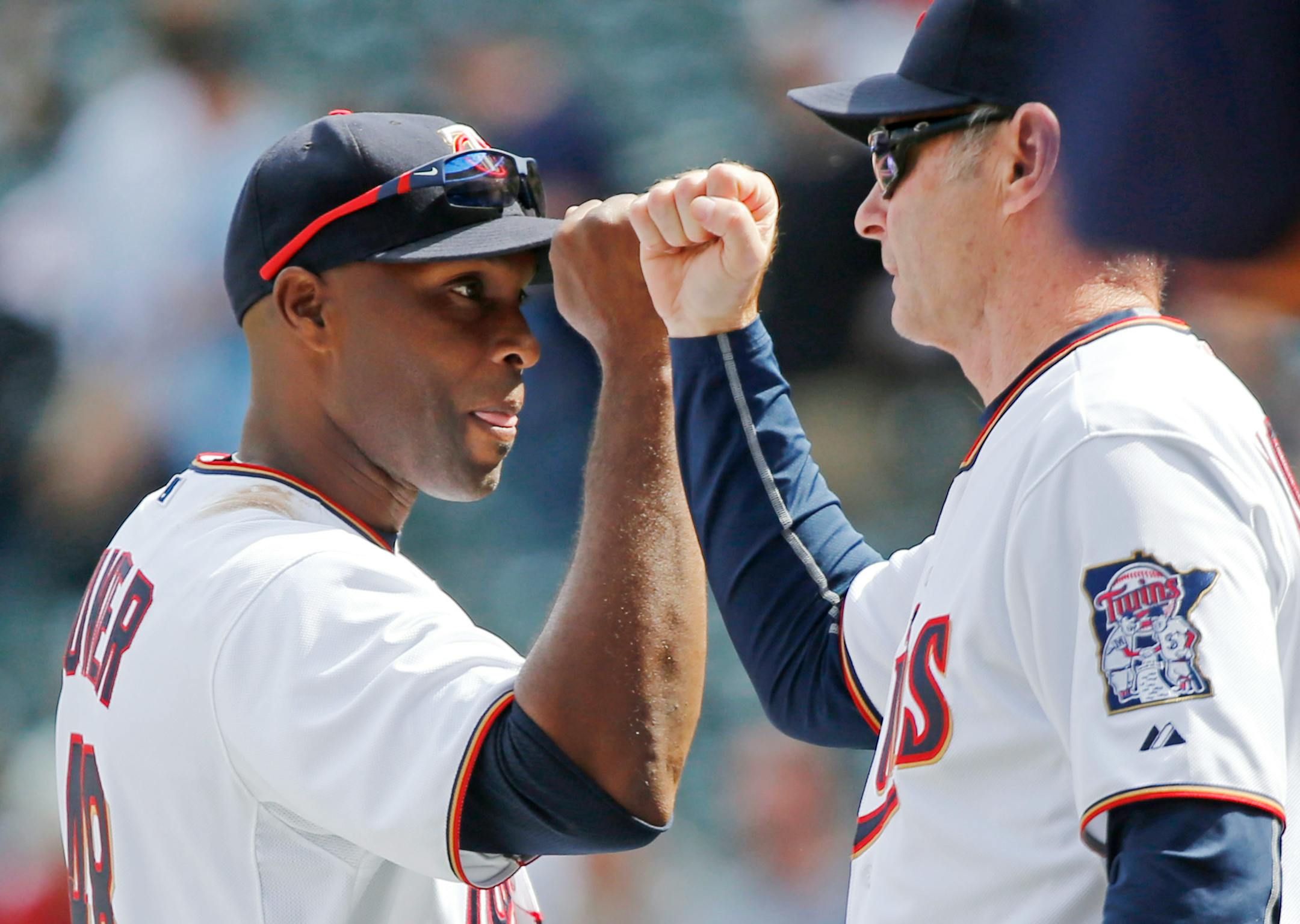 Minnesota Twins right fielder Torii Hunter, left, and Twins manager Paul Molitor bump fists following the Twins 8-5 win over the Kansas City Royals Thursday, April 16, 2015, at Target Field in Minneapolis, MN.
