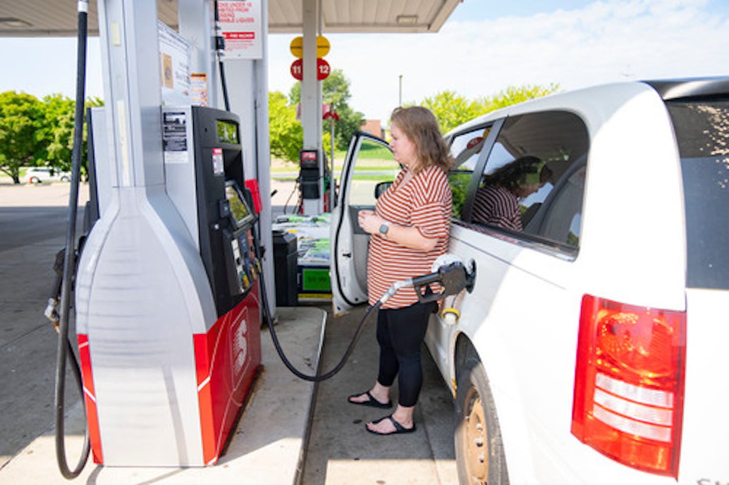 Elle Sammons pumps gas into her minivan Wednesday, August 17, 2022 at a Speedway gas station in Hastings, Minn. Gas prices in Hastings are lower than the rest of the state with current prices sitting at $3.41 at multiple locations, ]