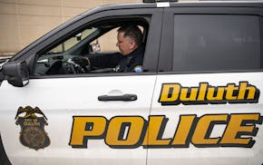 Duluth police Sgt. Steven Ring disinfected his squad car after his shift. The department has been hit by soaring numbers in the Northland, though it w