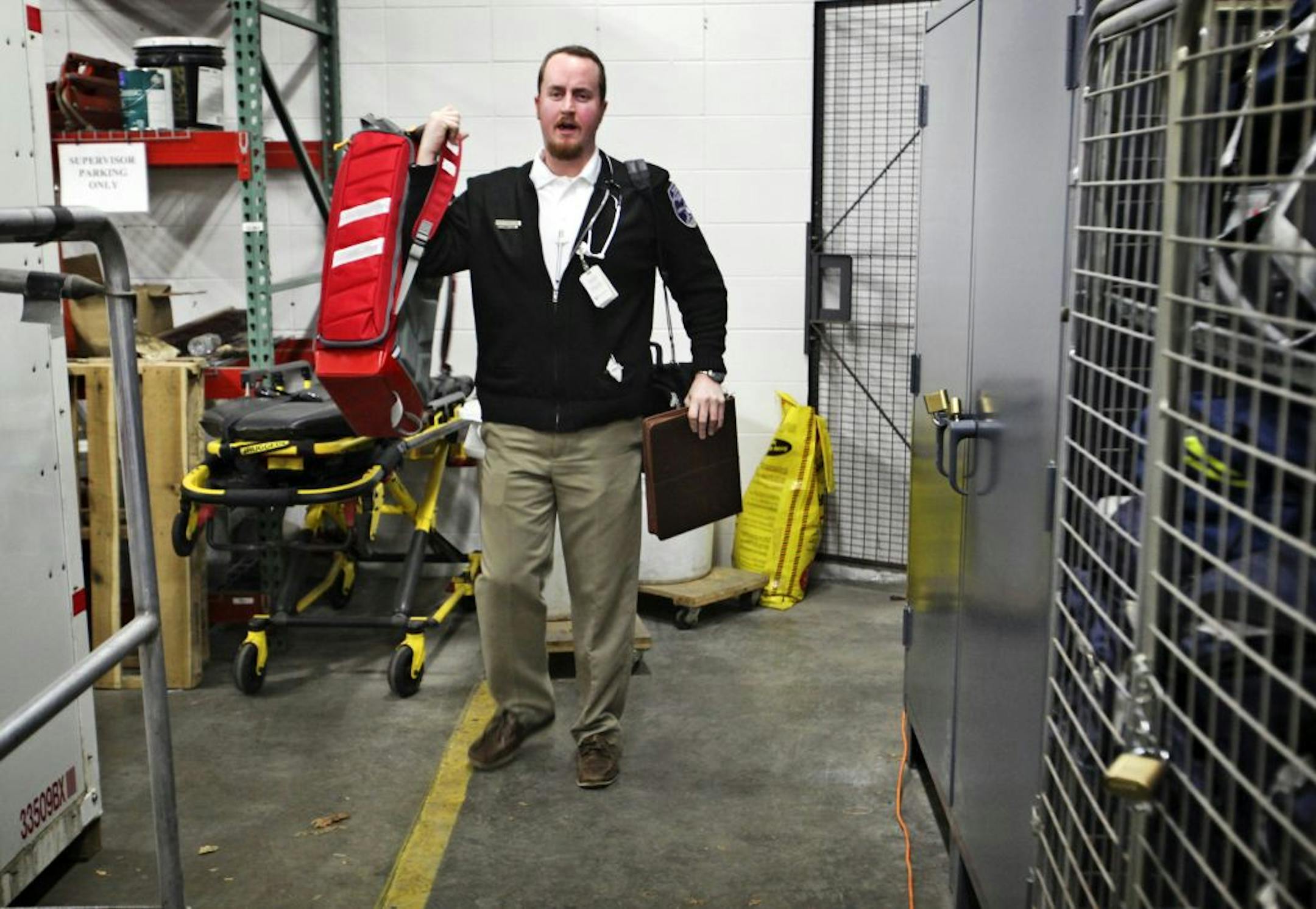 North Memorial community paramedic Peter Carlson begins his day at the ambulance garage, where he gathers up gear and supples for a day's worth of home visits.