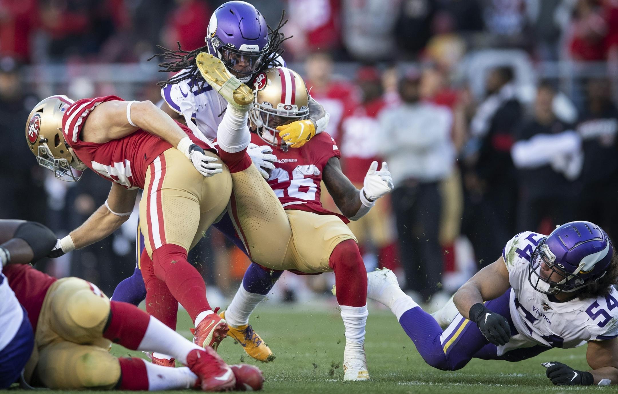 San Francisco 49ers running back Tevin Coleman (26) picked up a first down in the third quarter and was tackled Minnesota Vikings defensive back Anthony Harris (41) .