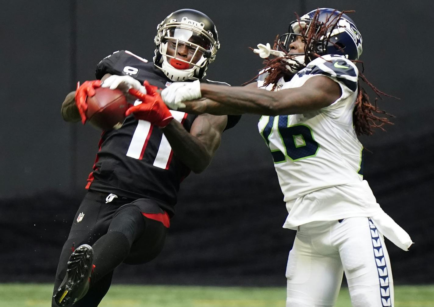 Atlanta Falcons wide receiver Julio Jones (11) makes the catch aganst Seattle Seahawks cornerback Shaquill Griffin (26) during the second half of an NFL football game, Sunday, Sept. 13, 2020, in Atlanta. (AP Photo/Brynn Anderson)