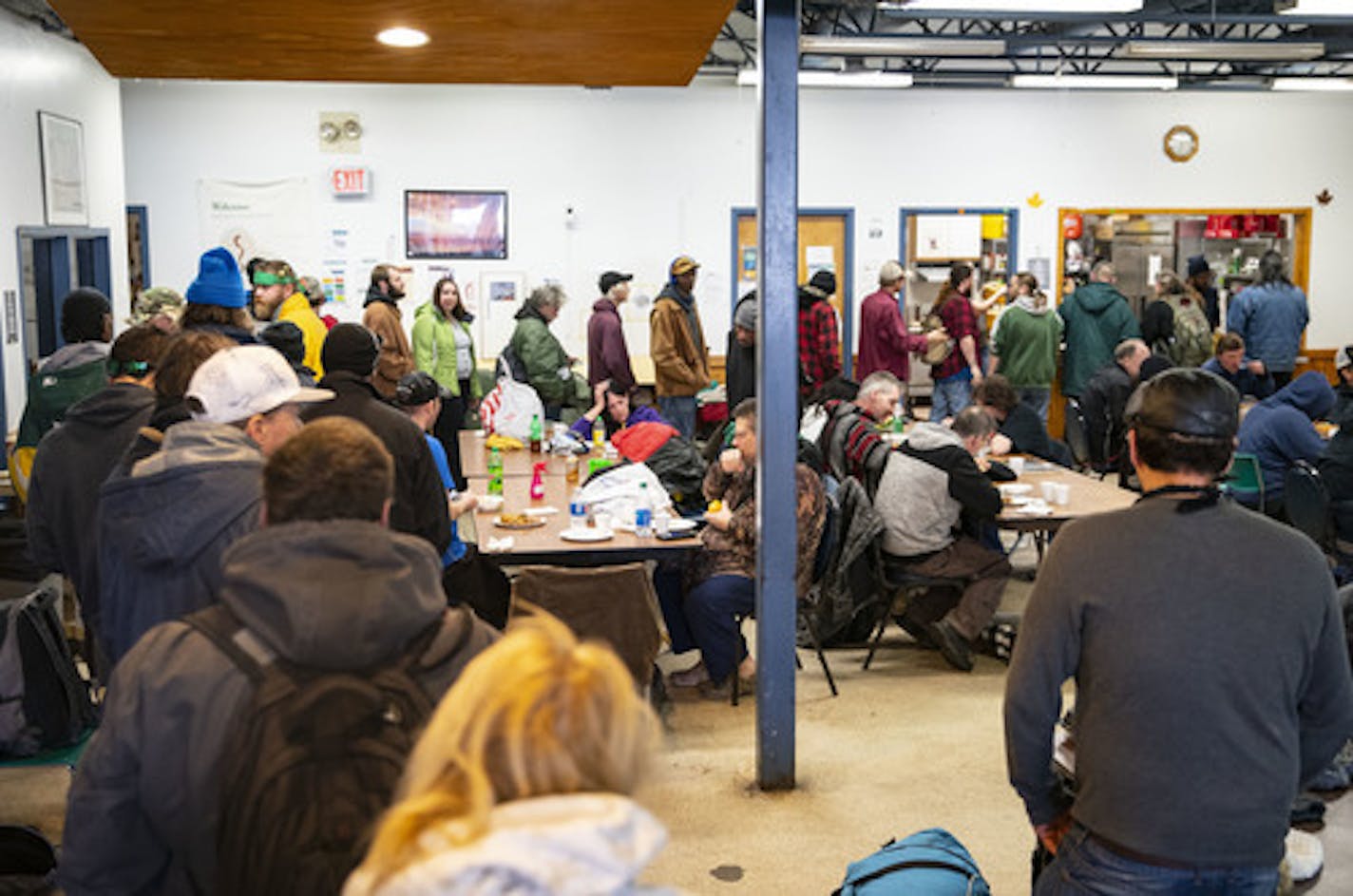 People line up for free lunch at CHUM Food Shelf in Duluth, MN on Tuesday March 17, 2020. With limited space and surging demand, it is nearly impossible to enforce social distancing and thus puts Duluth's vulnerable populations at greater risk of contracting COVID-19. ]
ALEX KORMANN &#x2022; alex.kormann@startribune.com CHUM in Duluth, MN is feeling the effects of COVID-19 with overcrowded spaces and no room to practice social distancing. They hope to be able to gain access to a larger temporary