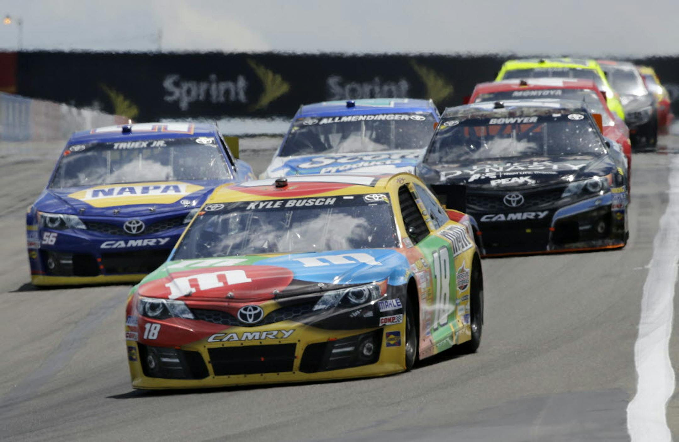 Kyle Busch (18) leads a group of racers during a NASCAR Sprint Cup Series auto race at The Glen Sunday,