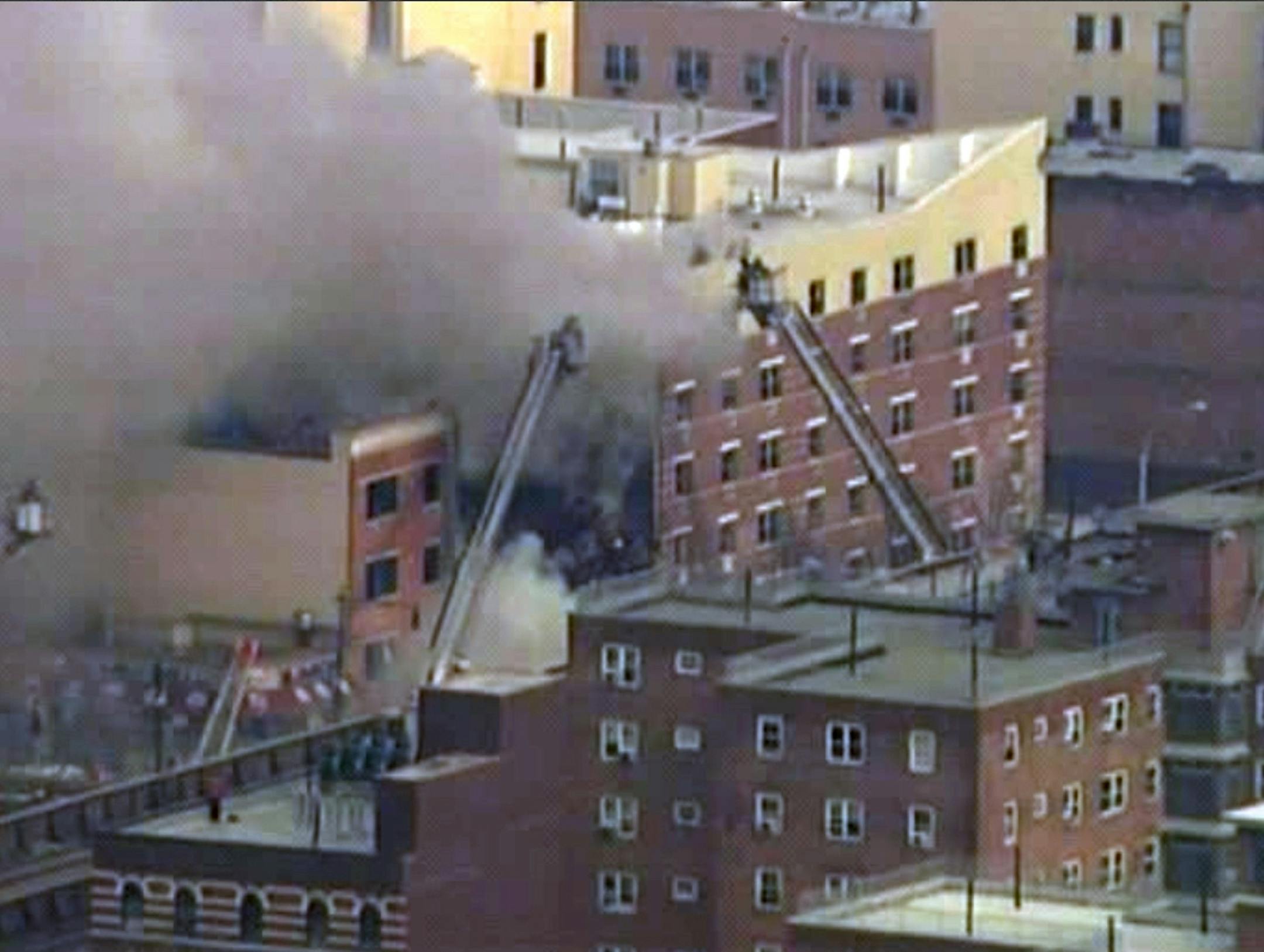 In this image taken from video from WABC, firefighters battle a blaze at the site of a possible explosion and building collapse in the East Harlem neighborhood of New York, Wednesday, March 12, 2014.