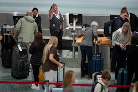 Travelers check into Delta flights in Terminal 1 at Minneapolis–Saint Paul International Airport on Nov. 22, 2023.