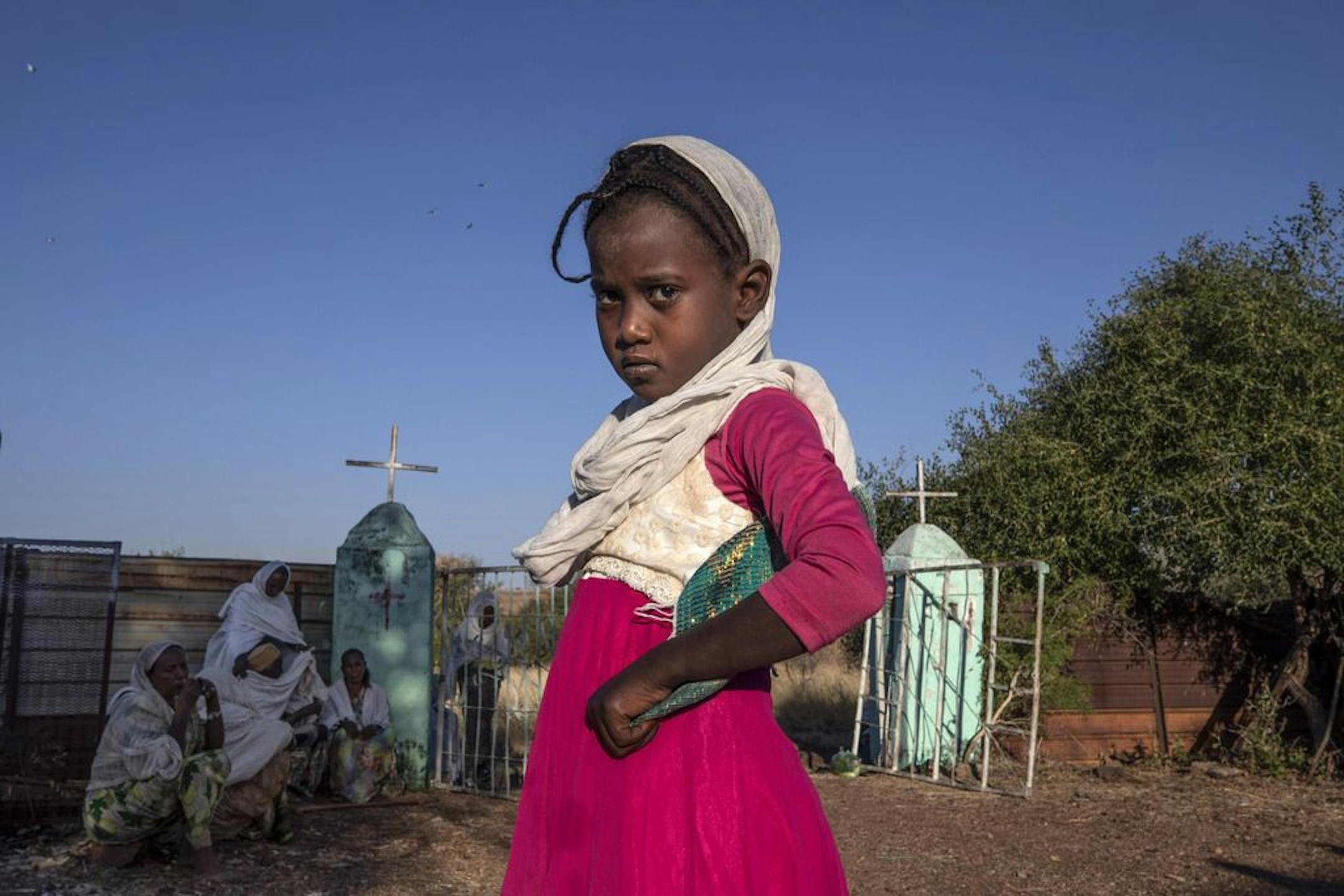 A Tigrayan girl who fled the conflict in Ethiopia's Tigray region, prepares to leave after Sunday Mass ends at a church, near Umm Rakouba refugee camp in Qadarif, eastern Sudan, Nov. 29, 2020.