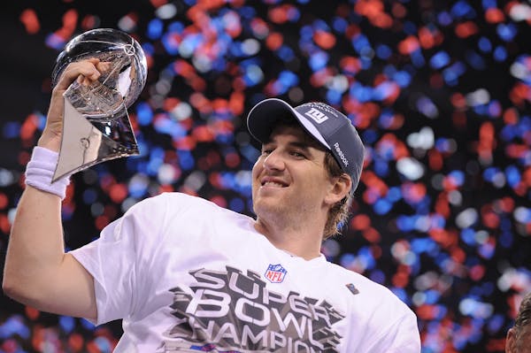 New York Giants quarterback Eli Manning celebrates with the Vince Lombardi Trophy at the end of Superbowl XLVI on Sunday, February 5, 2012, at Lucas O