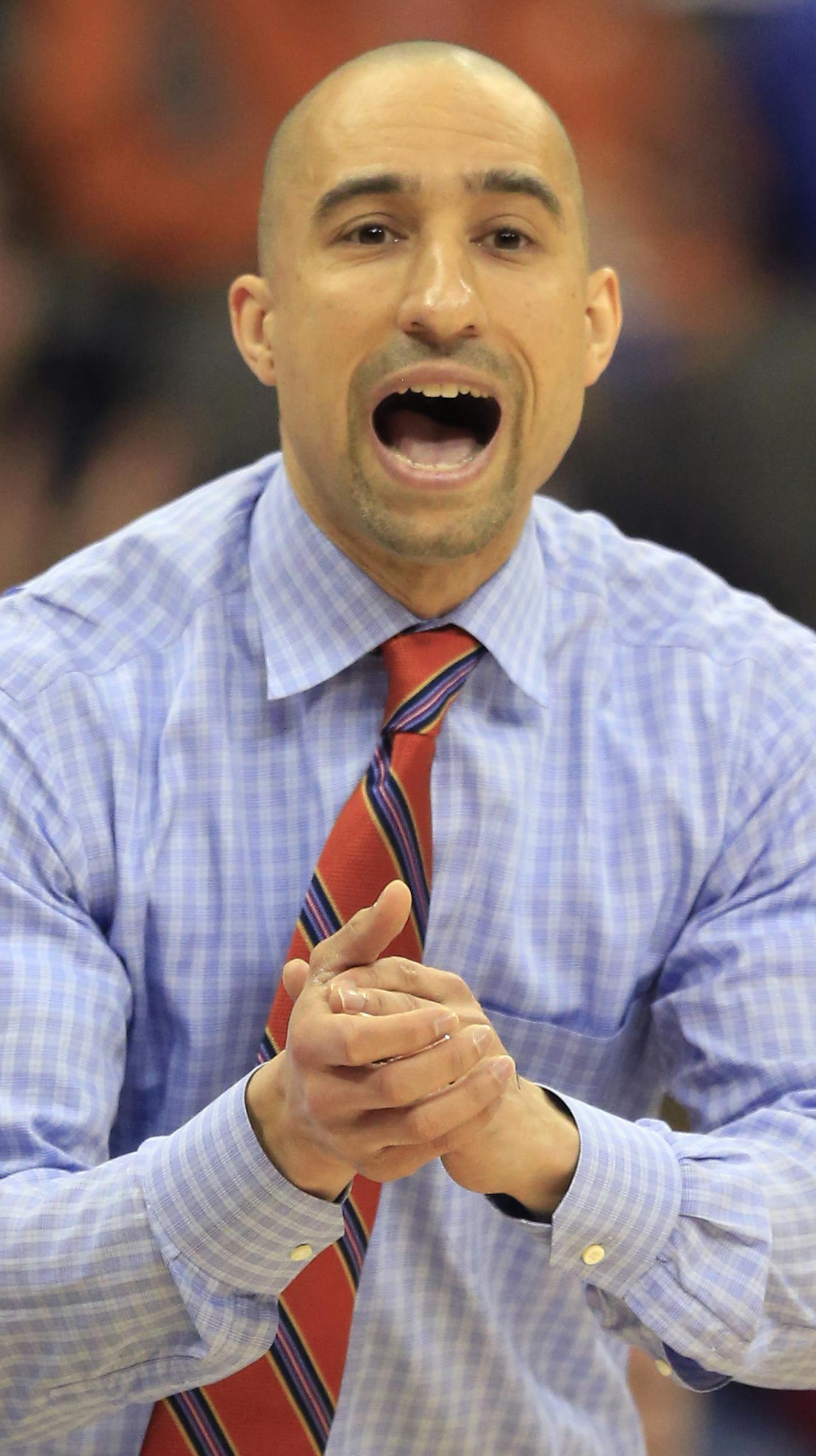 Texas head coach Shaka Smart yells to his team during the first half of an NCAA college basketball game against Baylor in the quarterfinals of the Big 12 conference tournament in Kansas City, Mo., Thursday, March 10, 2016. (AP Photo/Orlin Wagner)